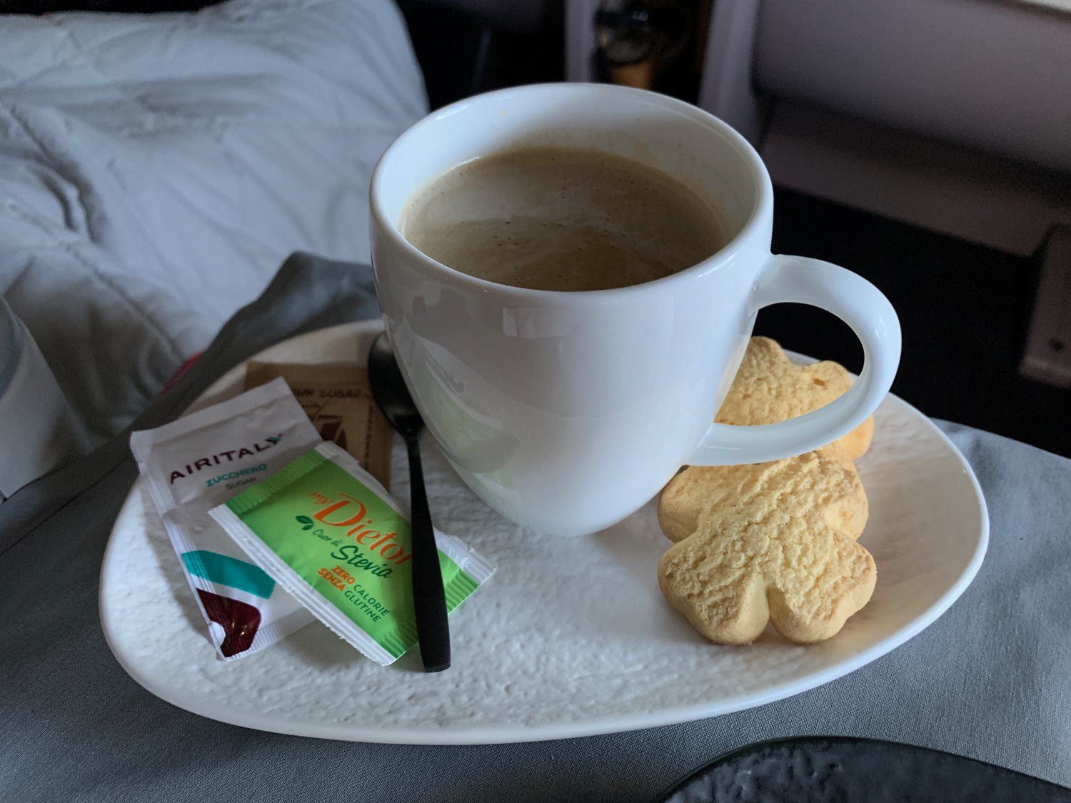 a cup of coffee and cookies on a plate