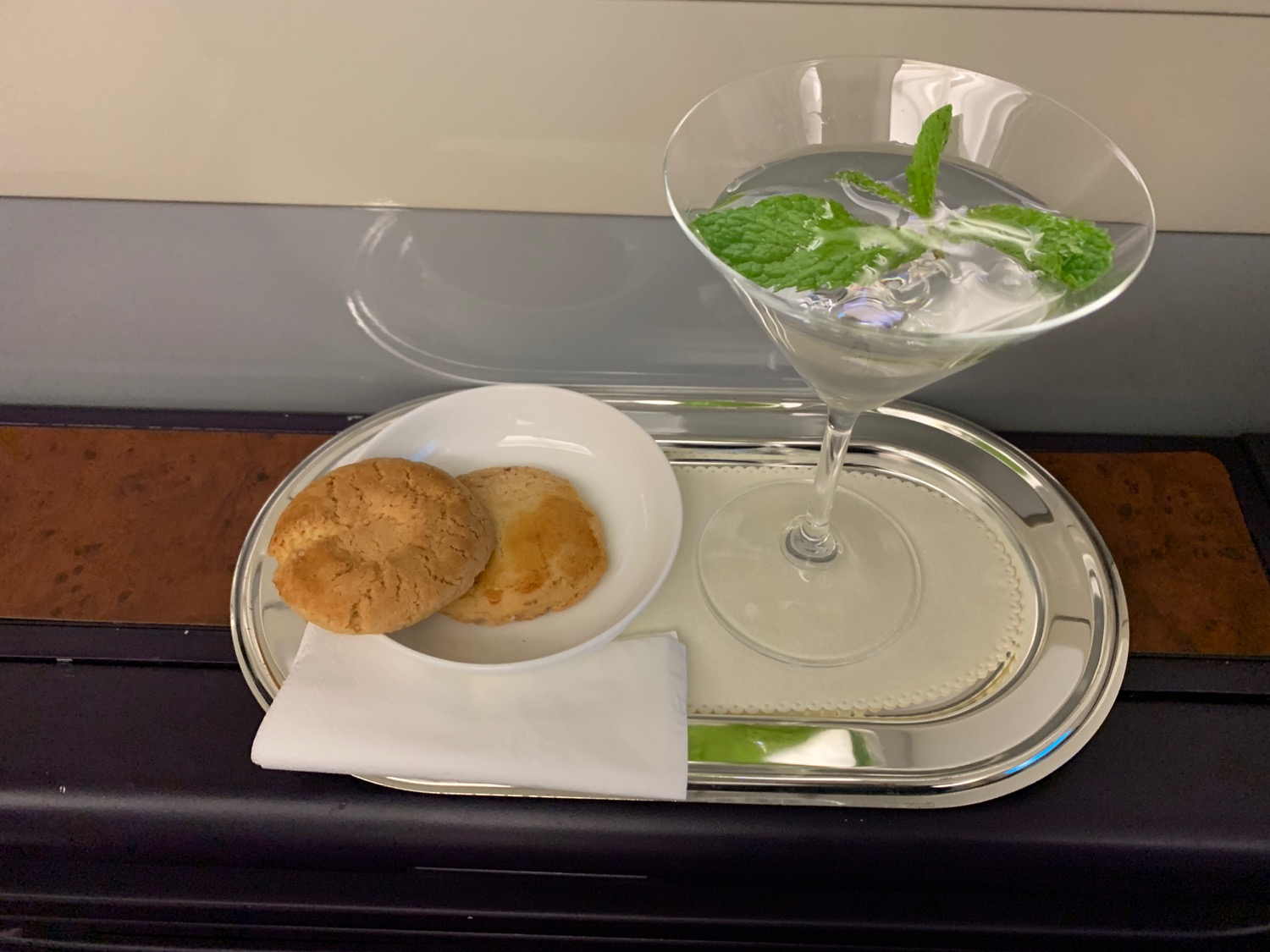 a plate of cookies and a martini glass on a tray