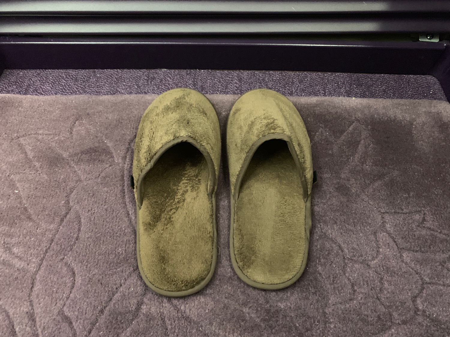 a pair of slippers on a rug