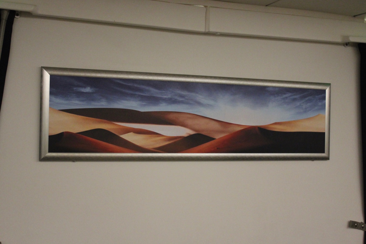 a picture of sand dunes on a wall