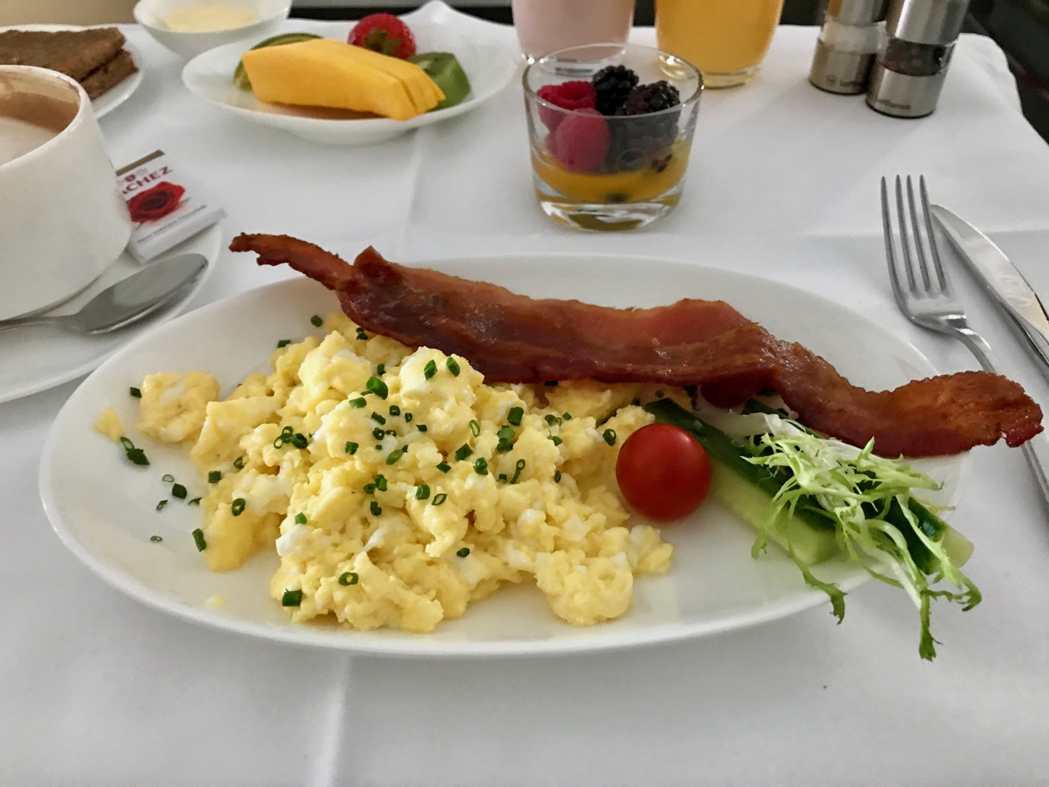 a plate of scrambled eggs and bacon