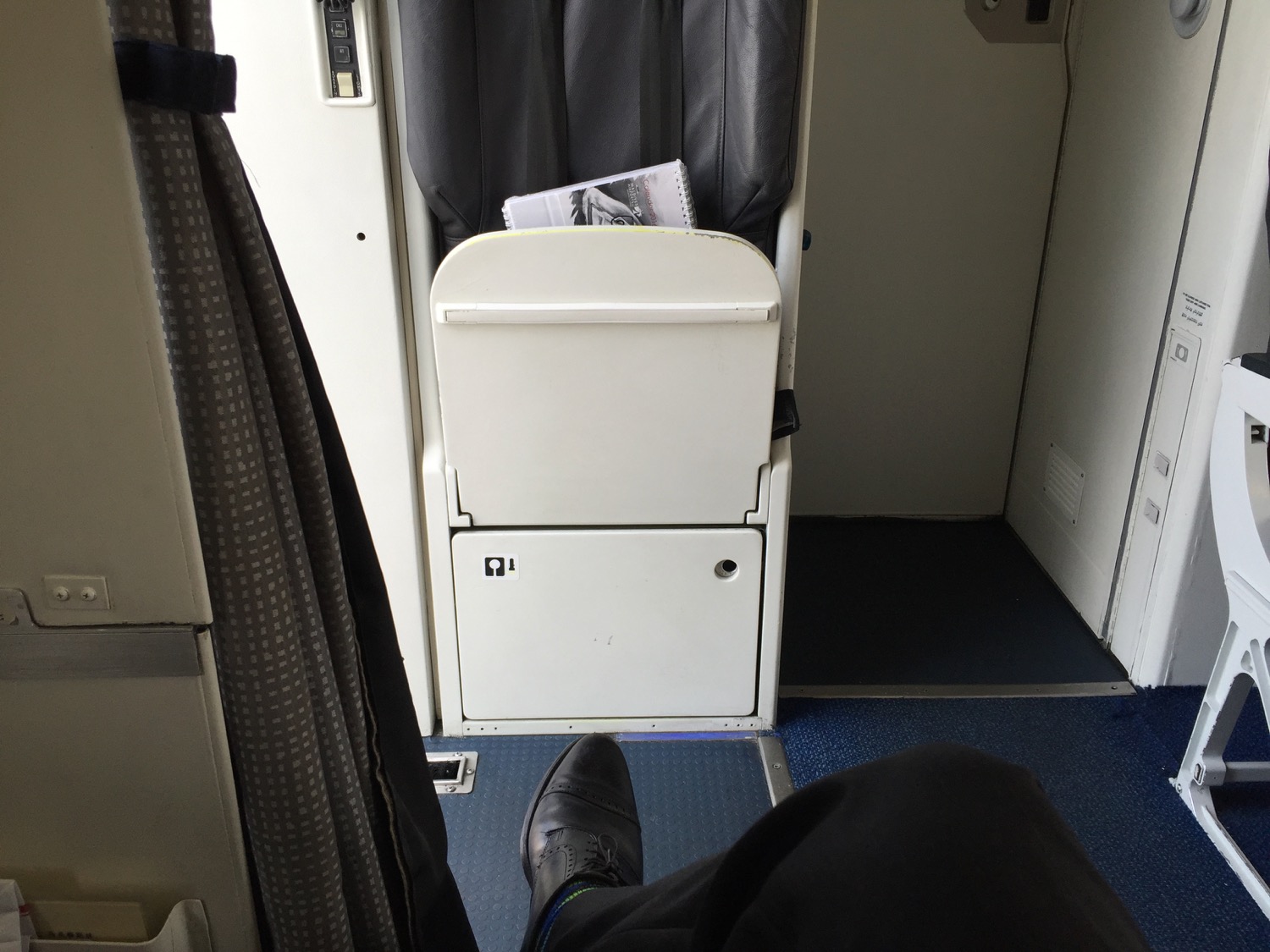 a person's feet in a chair in a plane