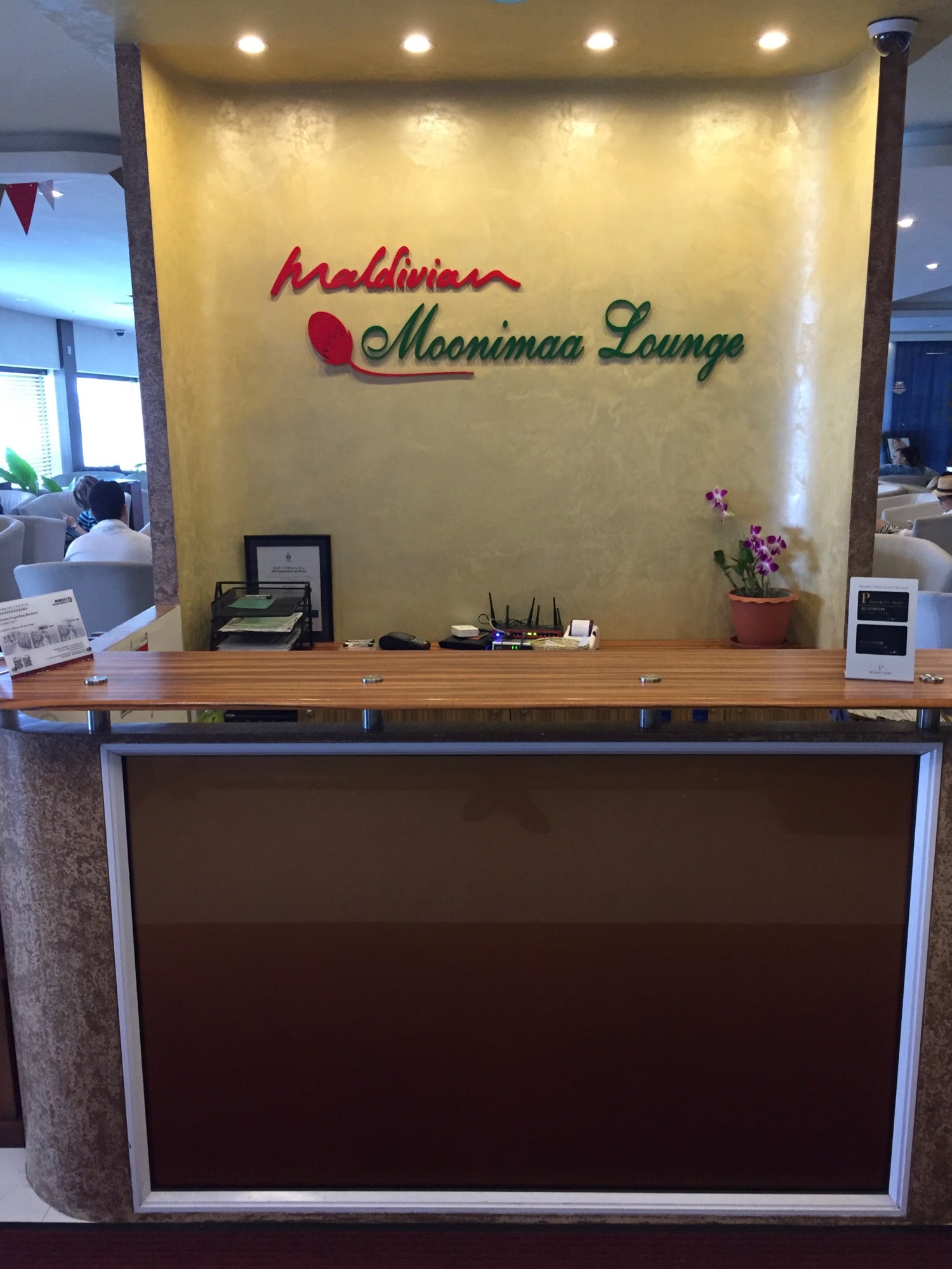 a reception desk with a sign on the wall