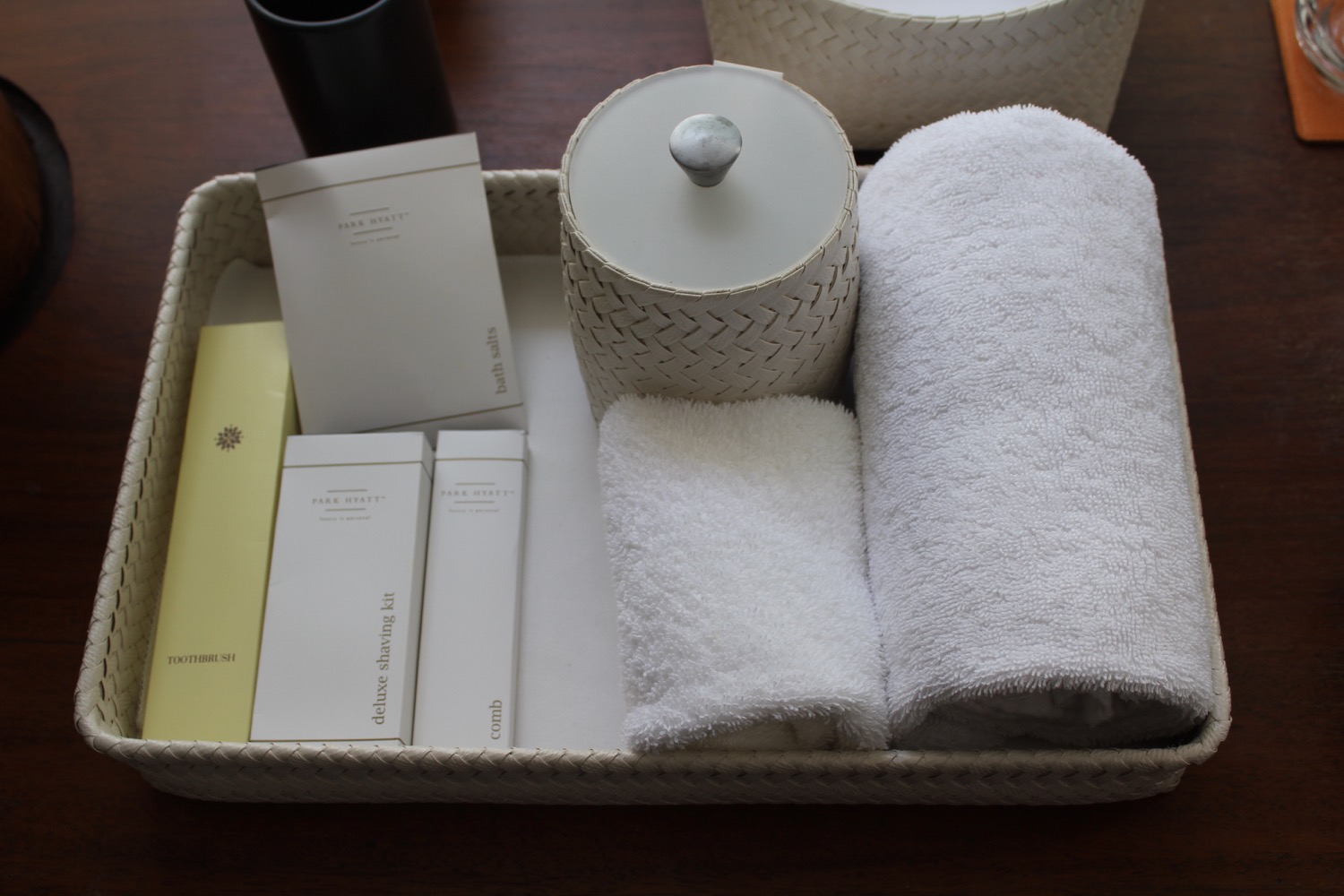 a tray with white towels and a candle