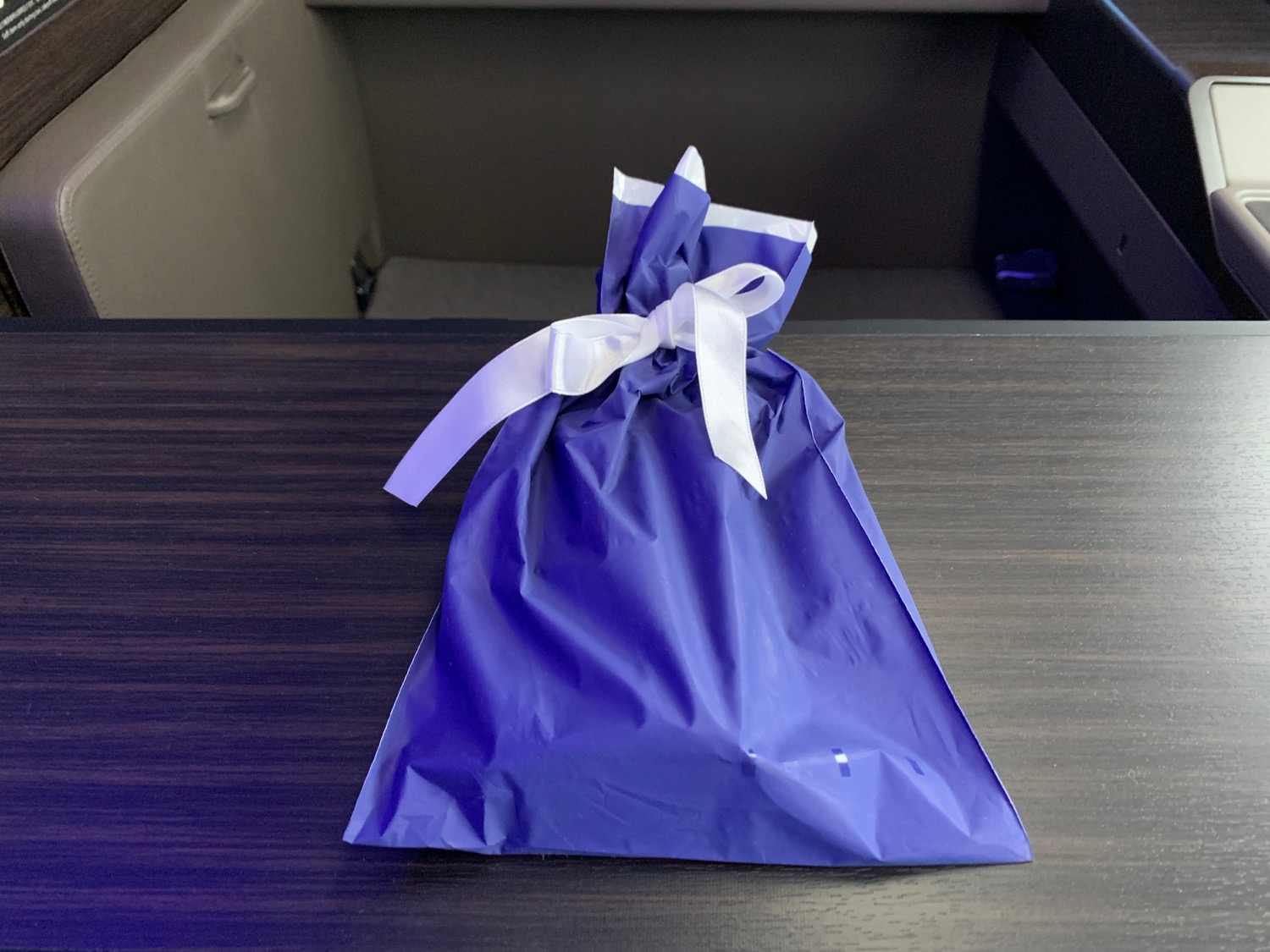 a blue bag with a white bow on a table