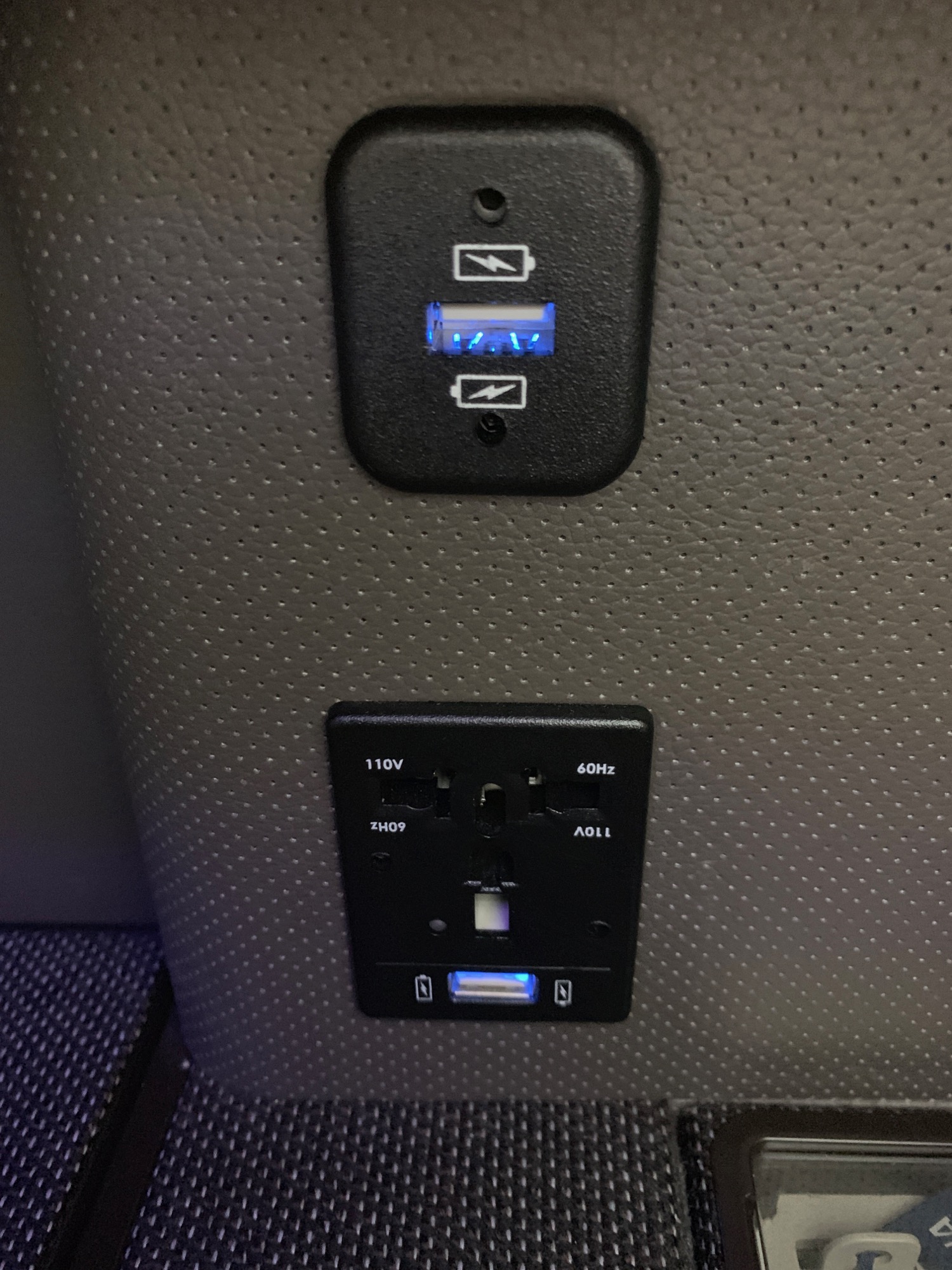 a black outlet with blue lights on the side of the seat
