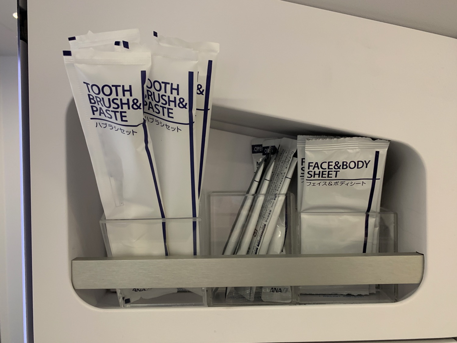 a group of toothbrushes and toothpaste in a shelf