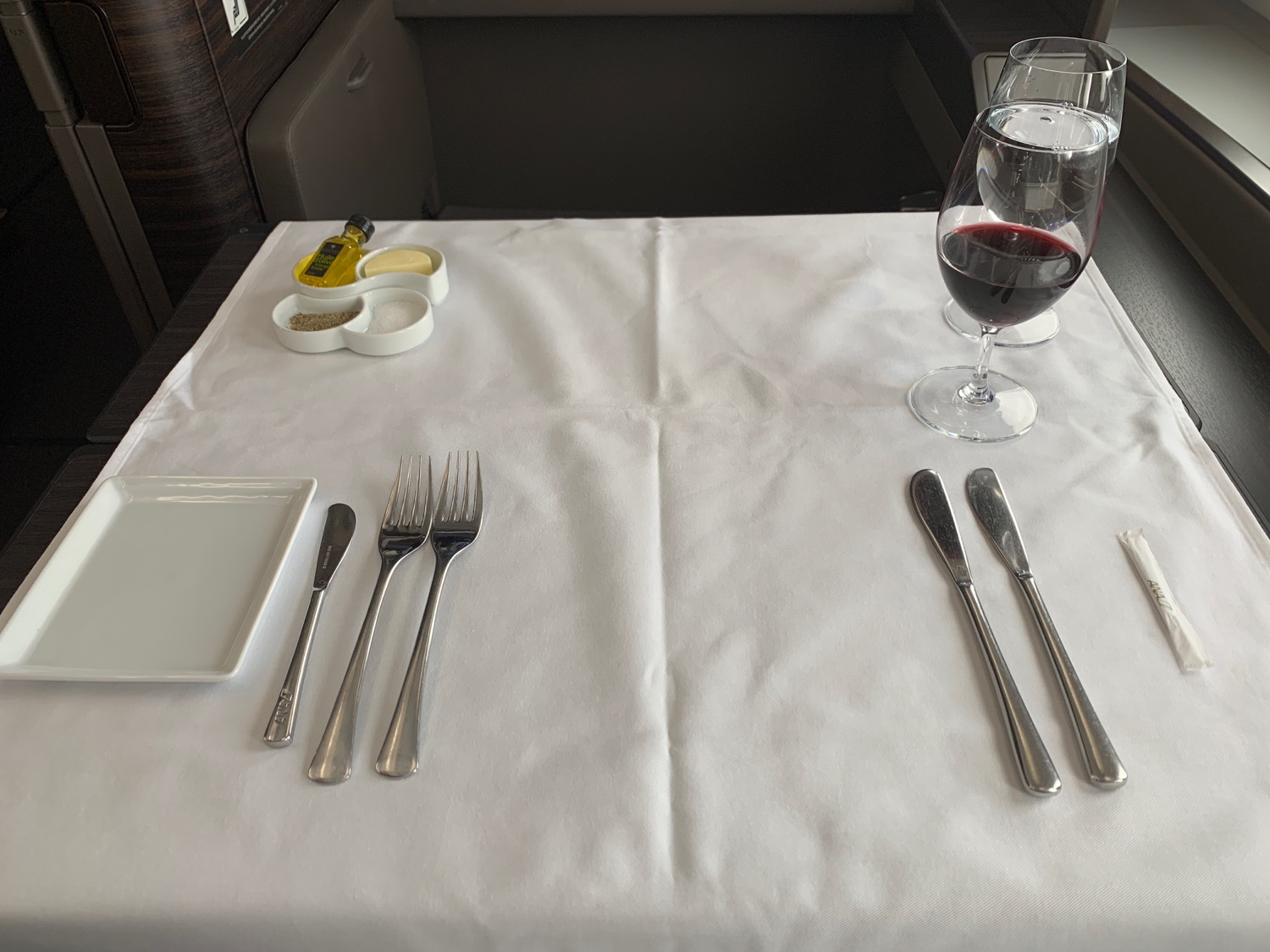 a table with a white tablecloth and silverware