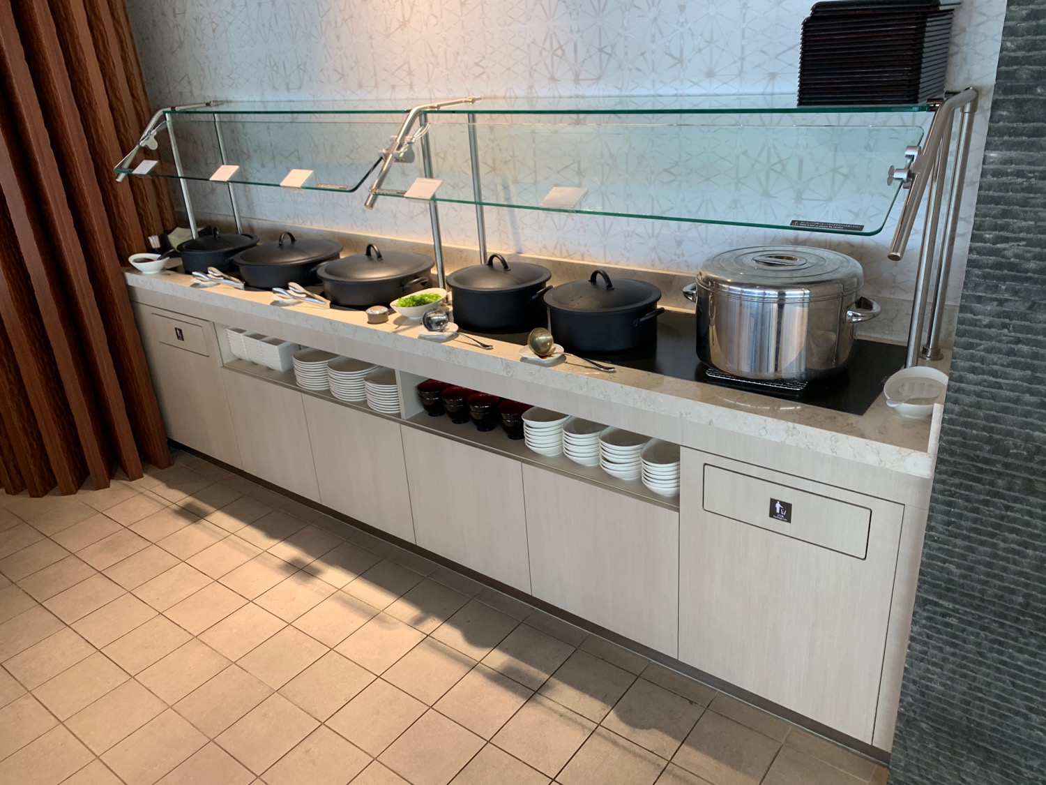 a buffet line with many pots and pans