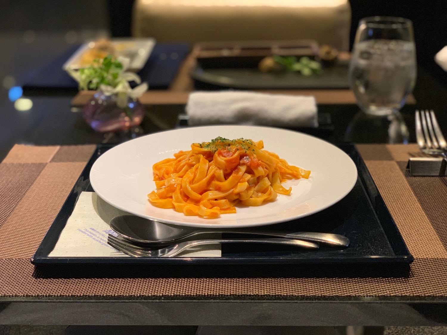 a plate of pasta on a tray