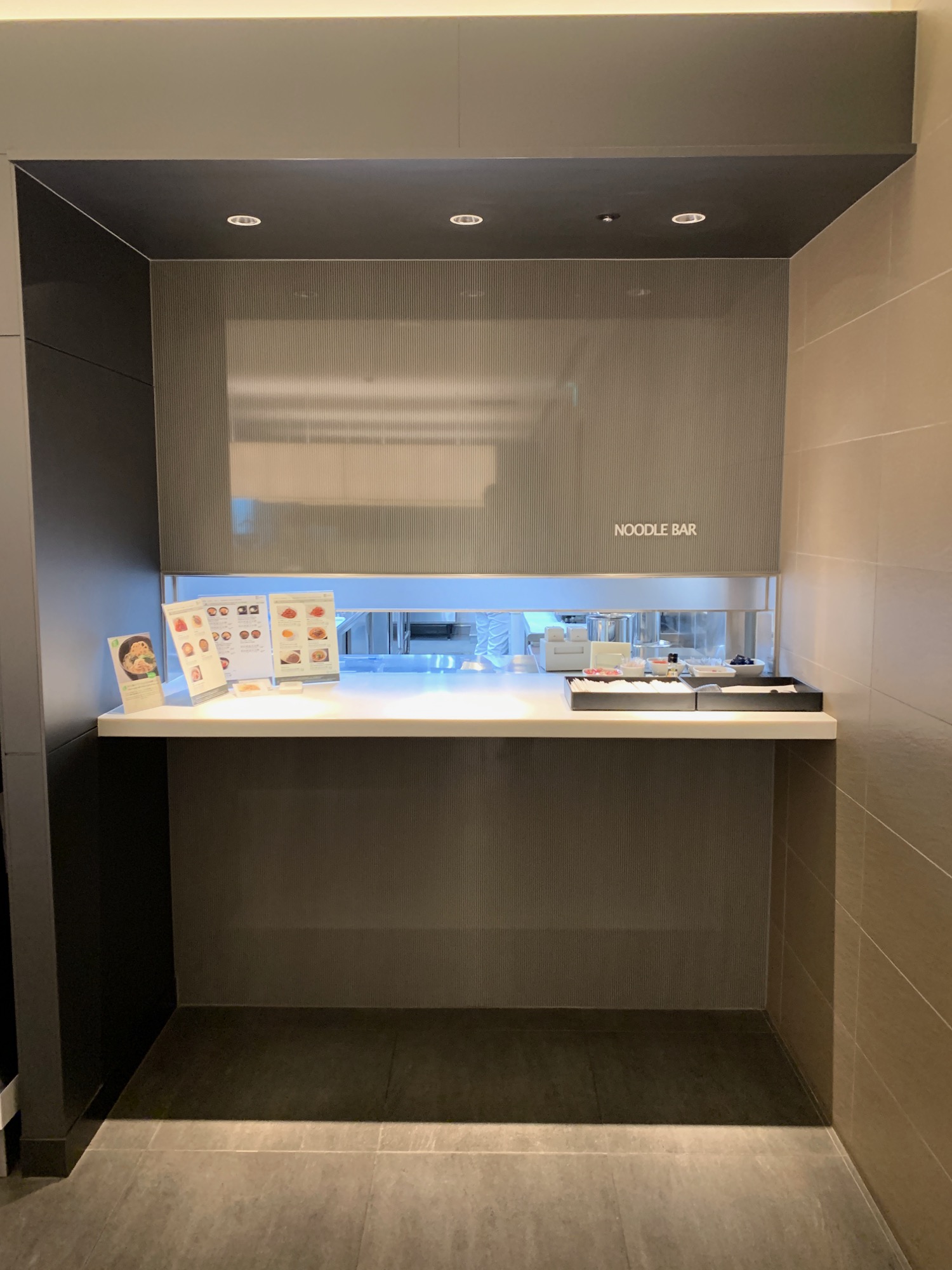 a noodle bar with food on the counter