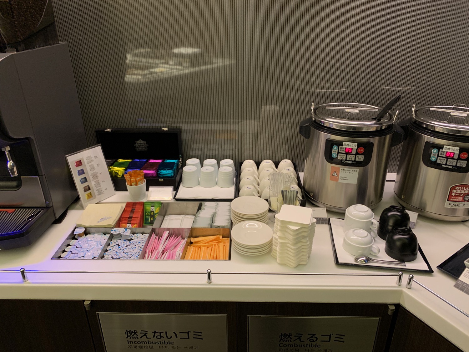 a counter with a variety of coffee and tea items