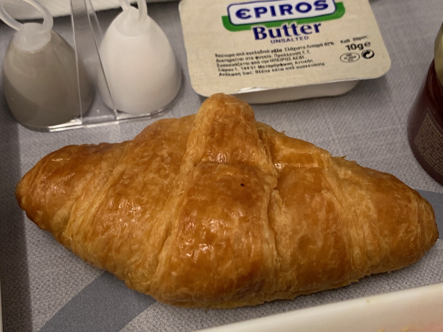 a croissant and butter on a table