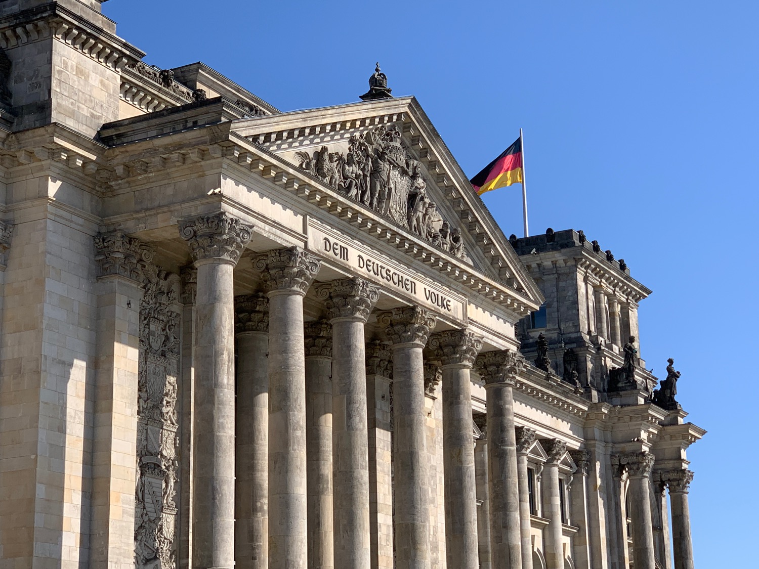 Reichstag building with columns and a flag on top