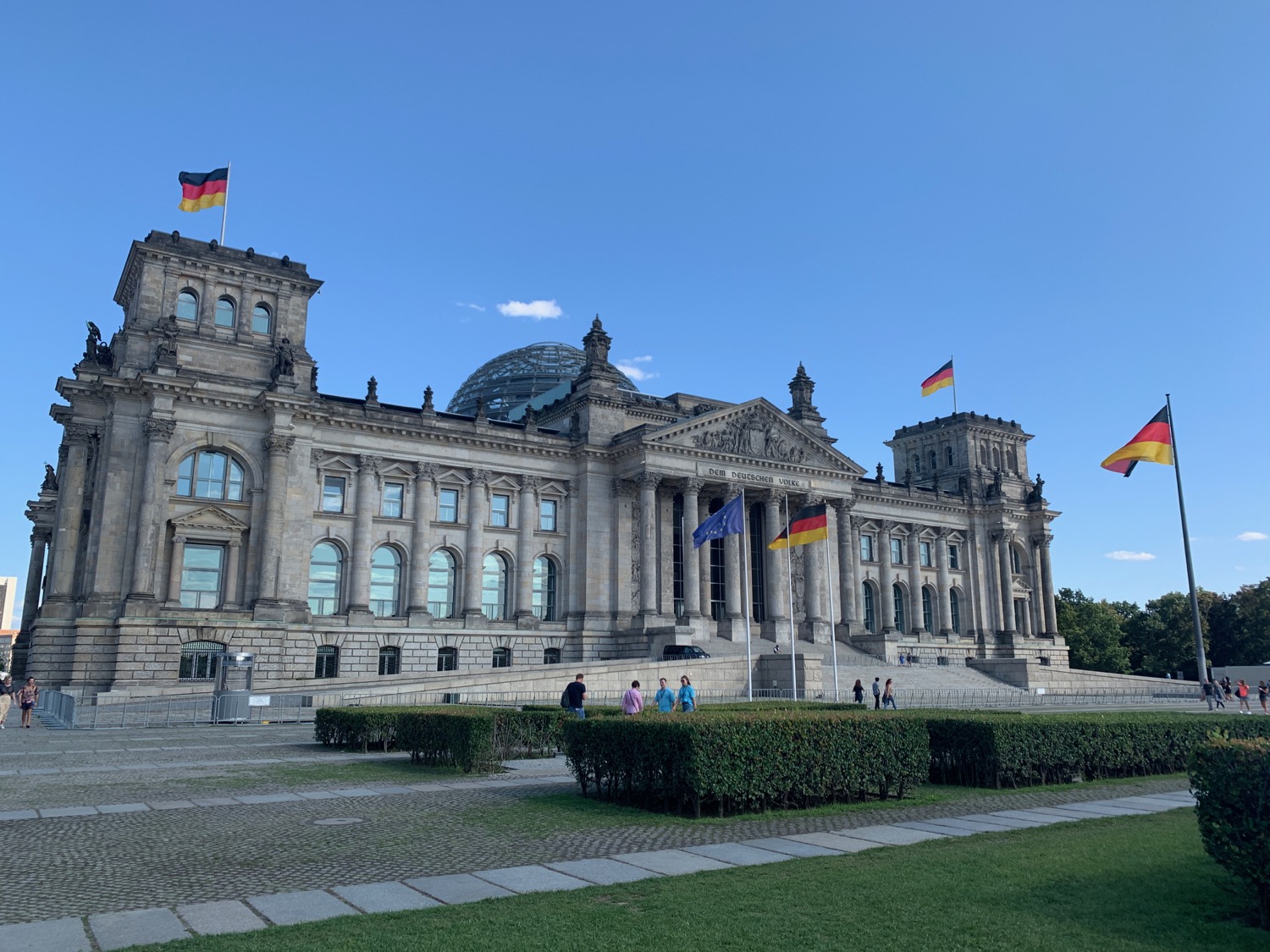 Reichstag building with flags on top of it