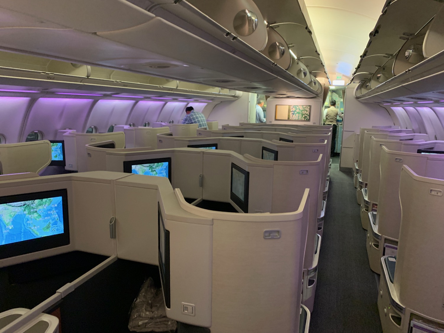 an airplane with a row of seats and monitors