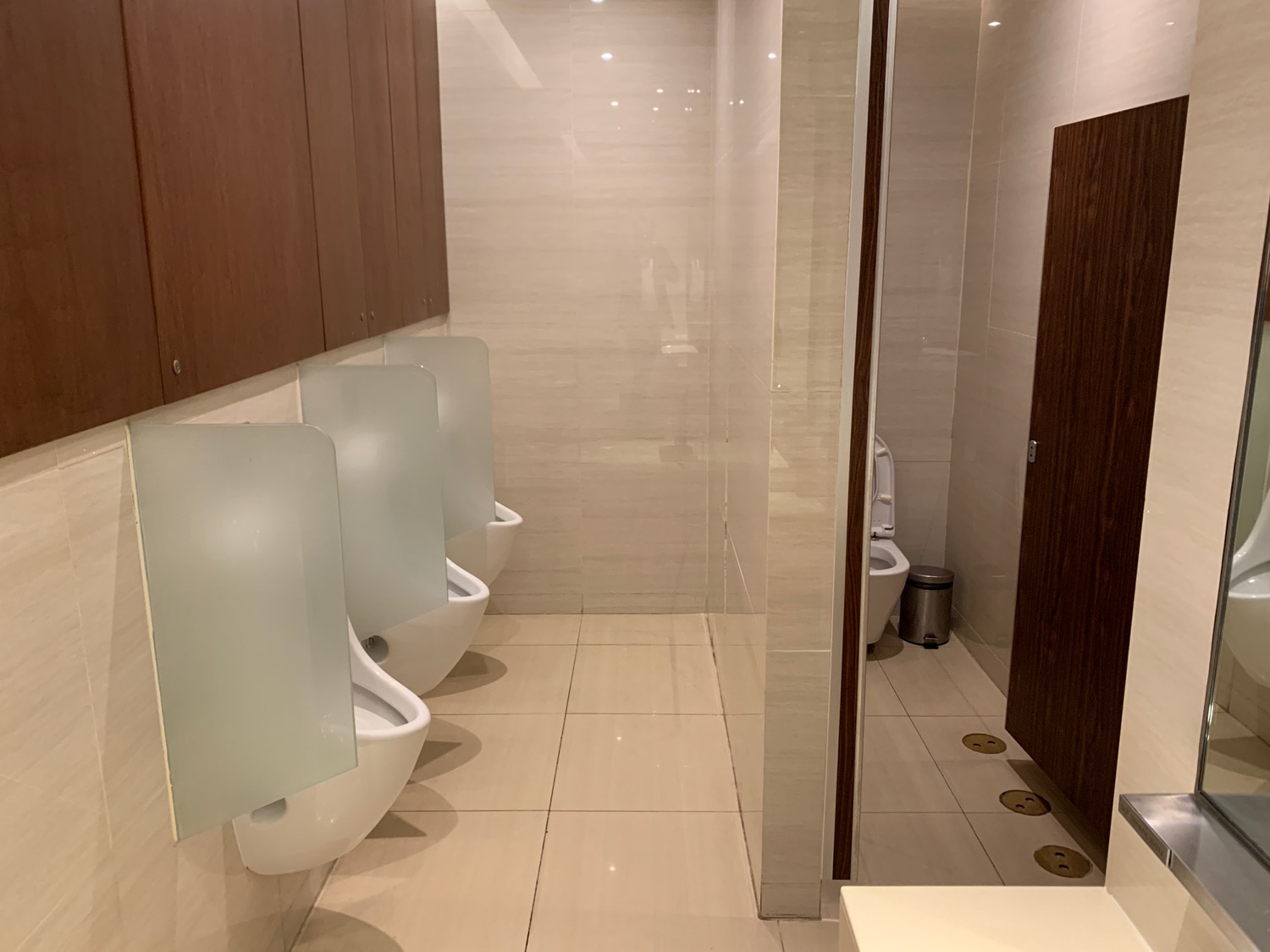 a bathroom with urinals and a shower