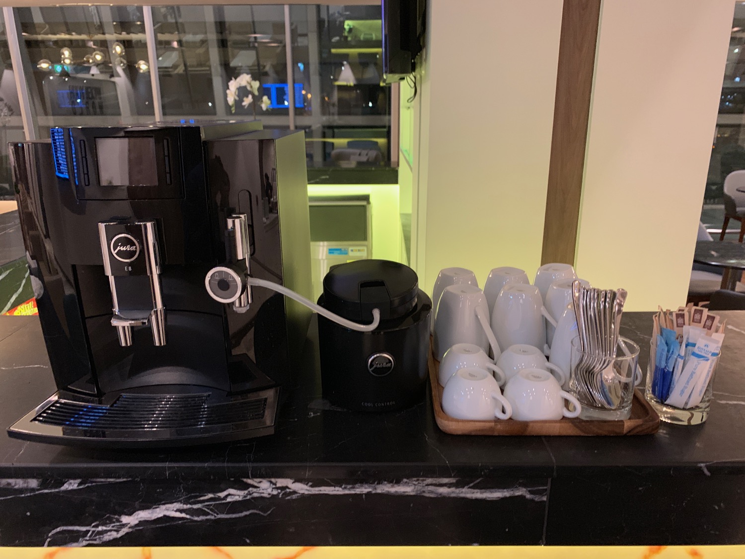 a coffee machine and cups on a counter