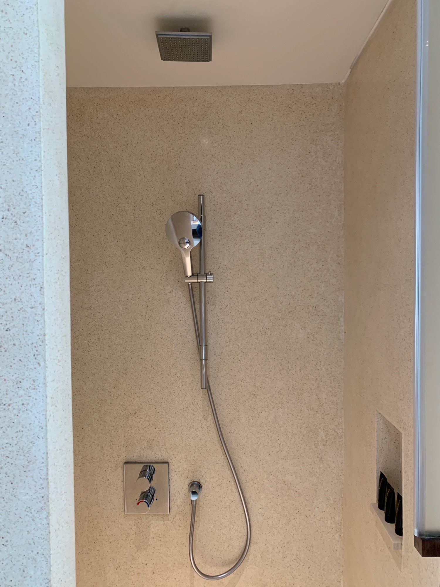 a shower head and hose on a wall