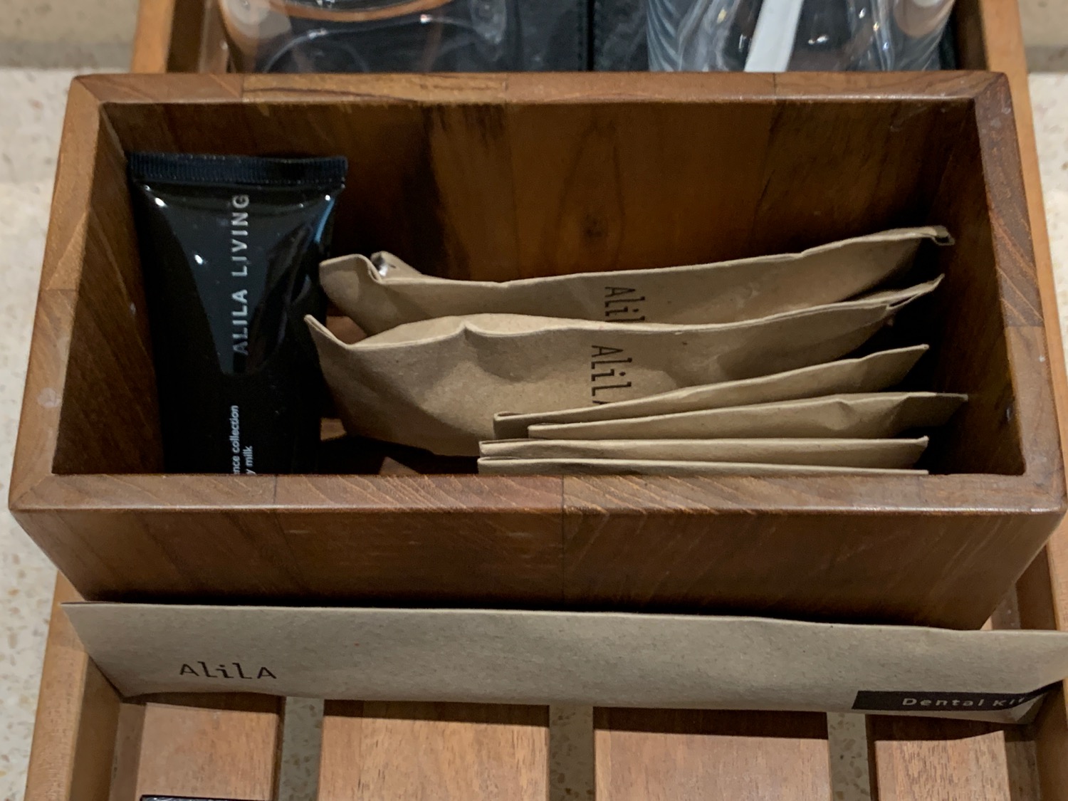a wooden box with brown paper bags and a black tube