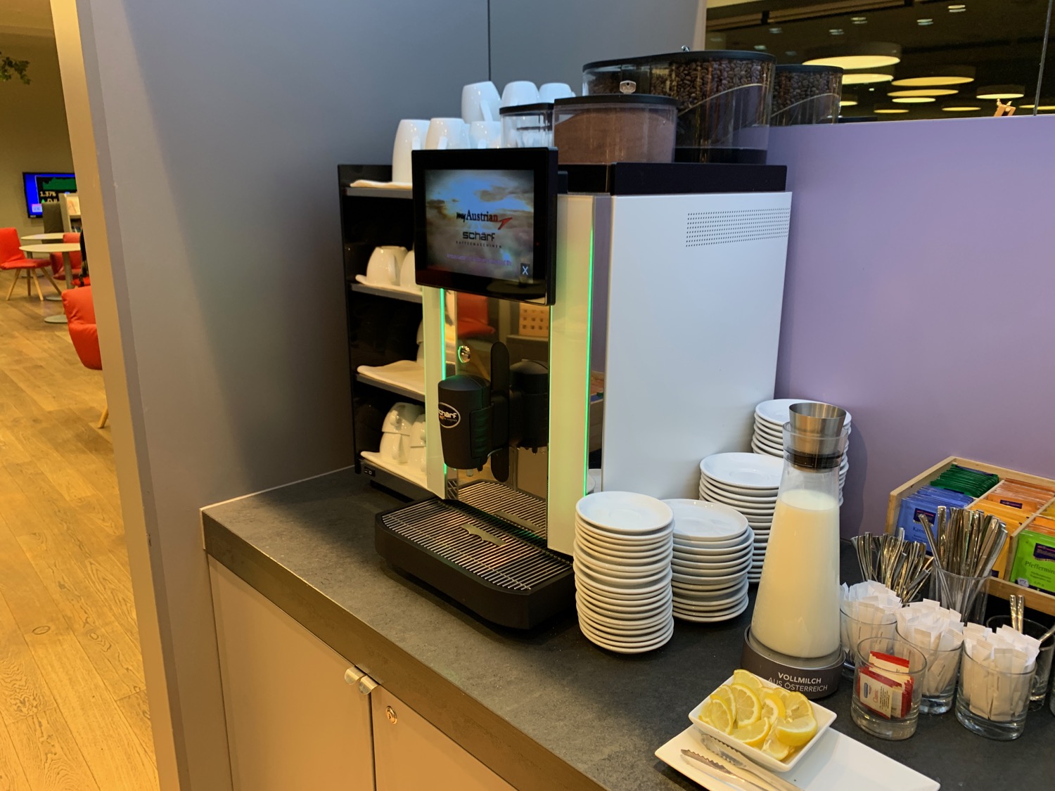 a coffee machine and a shelf of plates