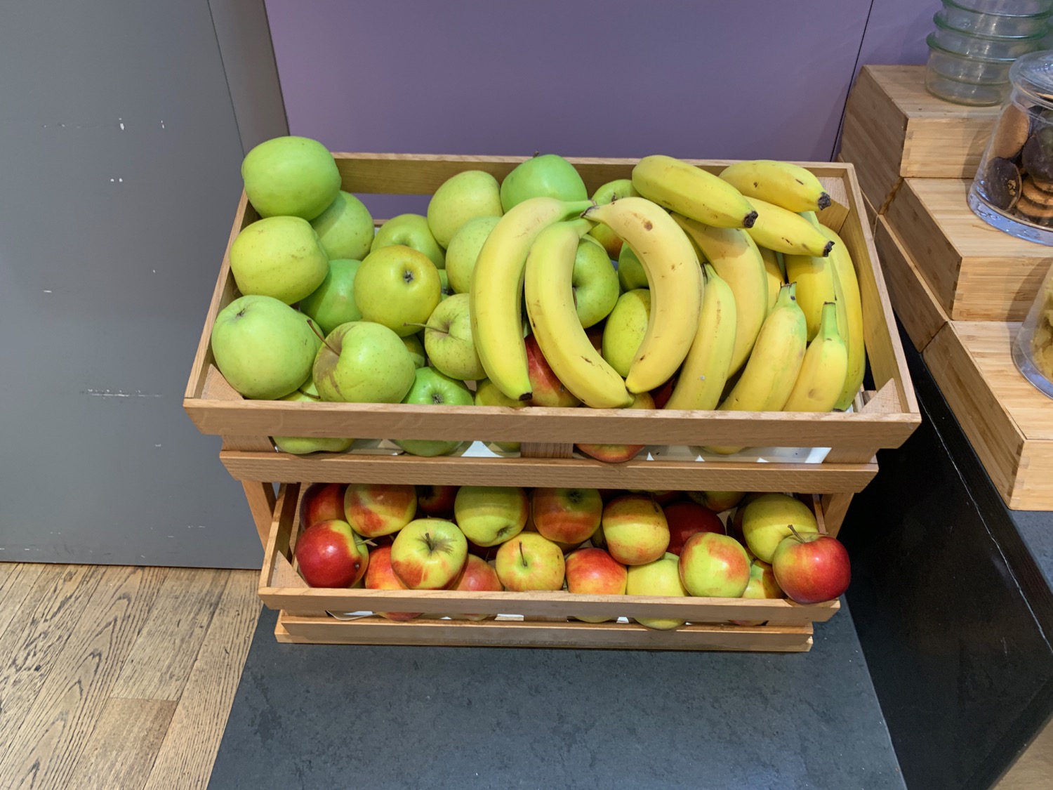a wooden crate full of apples and bananas