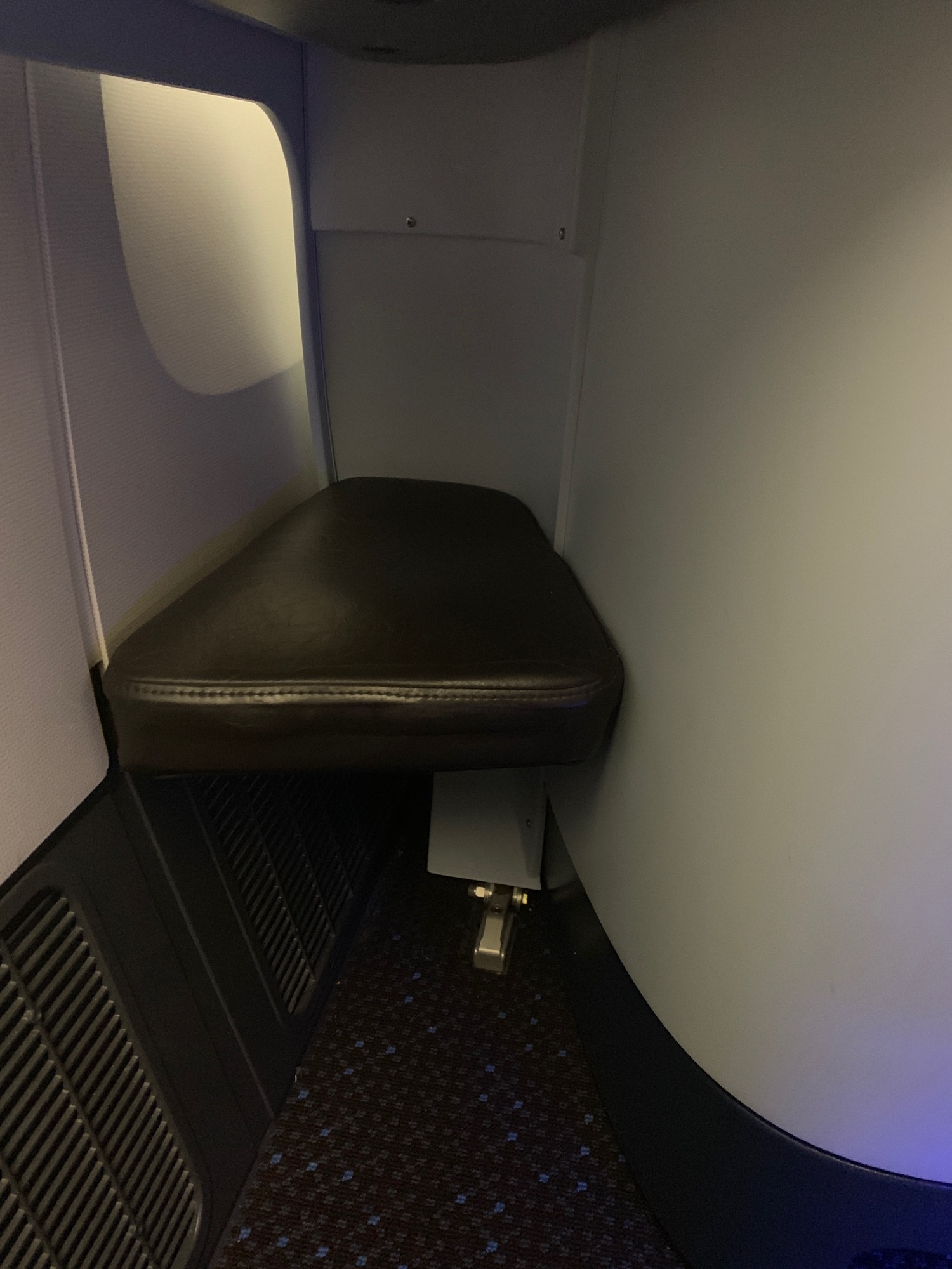 a seat in a corner of a plane