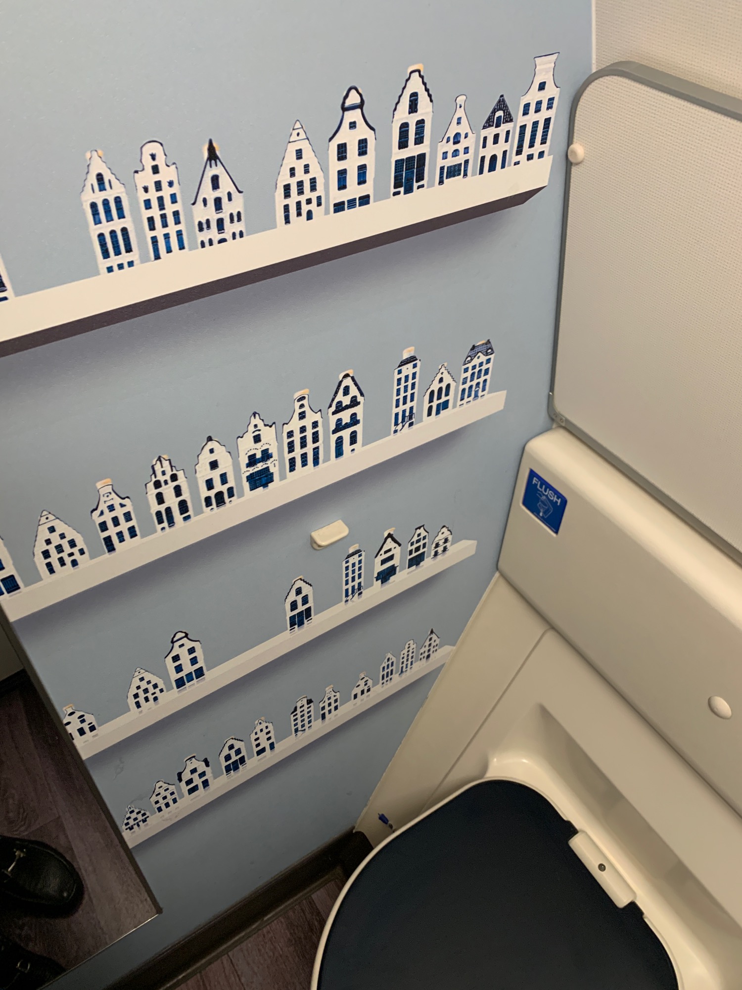 a shelf with paper cut out of houses on it