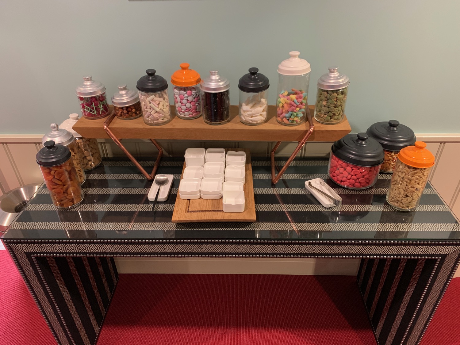 a table with different types of candy in jars