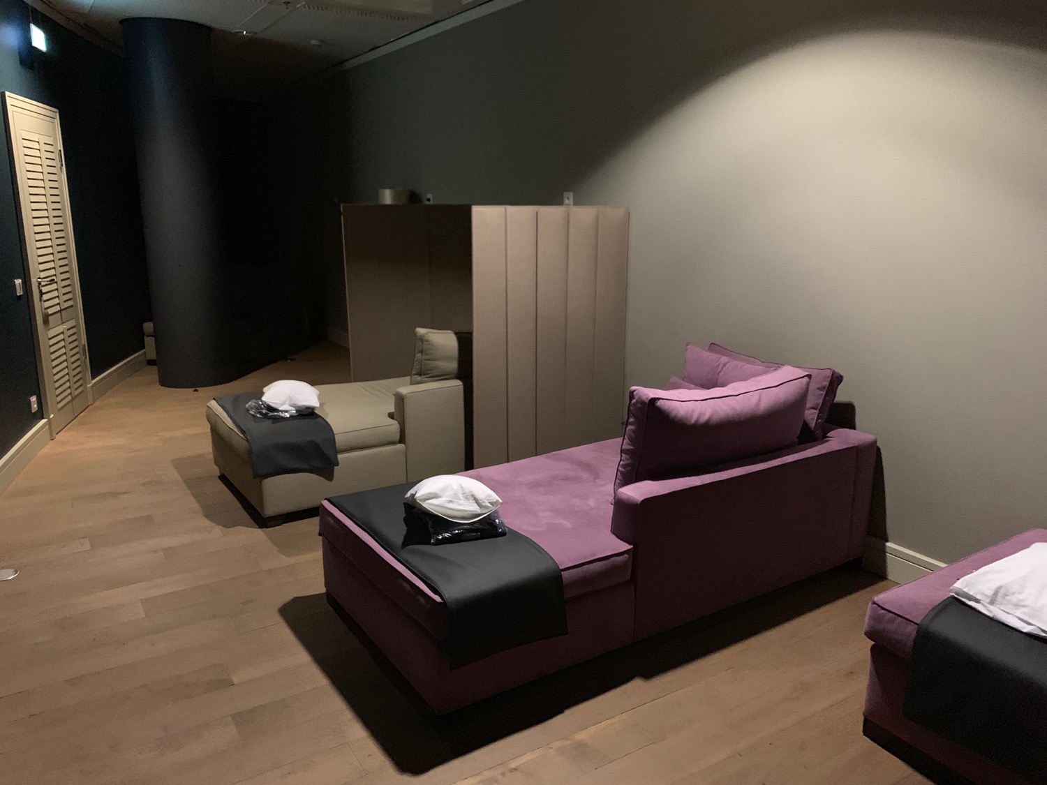 a room with purple couches and a wood floor