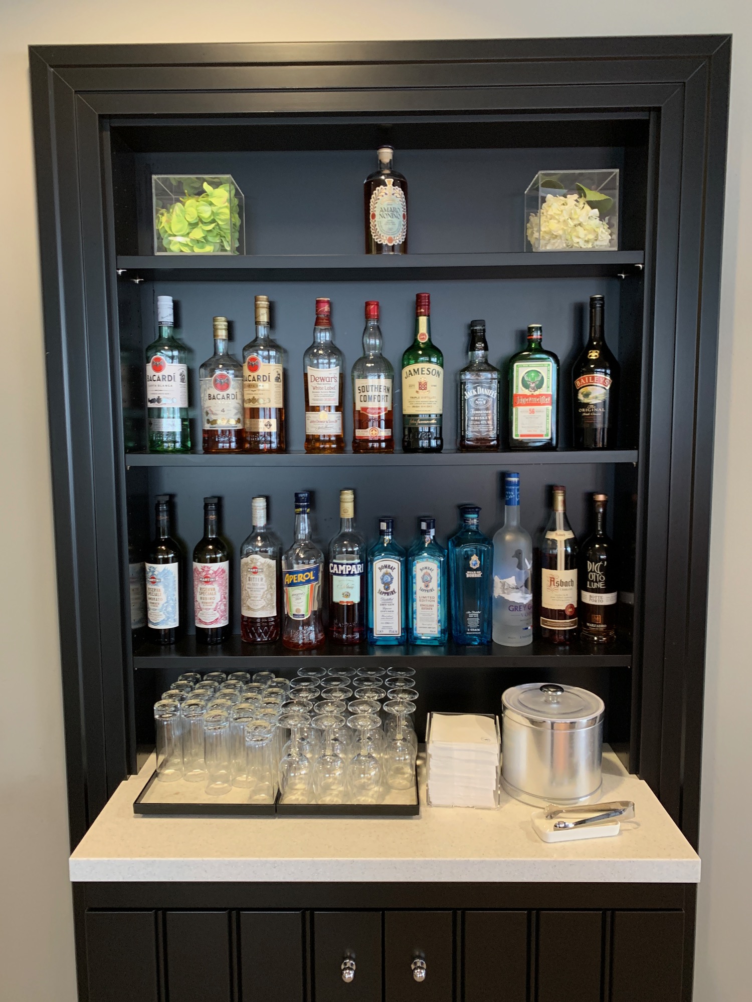 a shelf with bottles and glasses