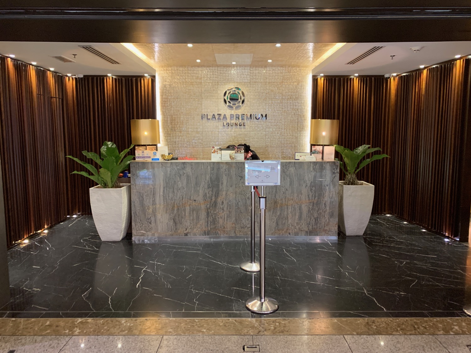 a lobby with a marble counter and plants