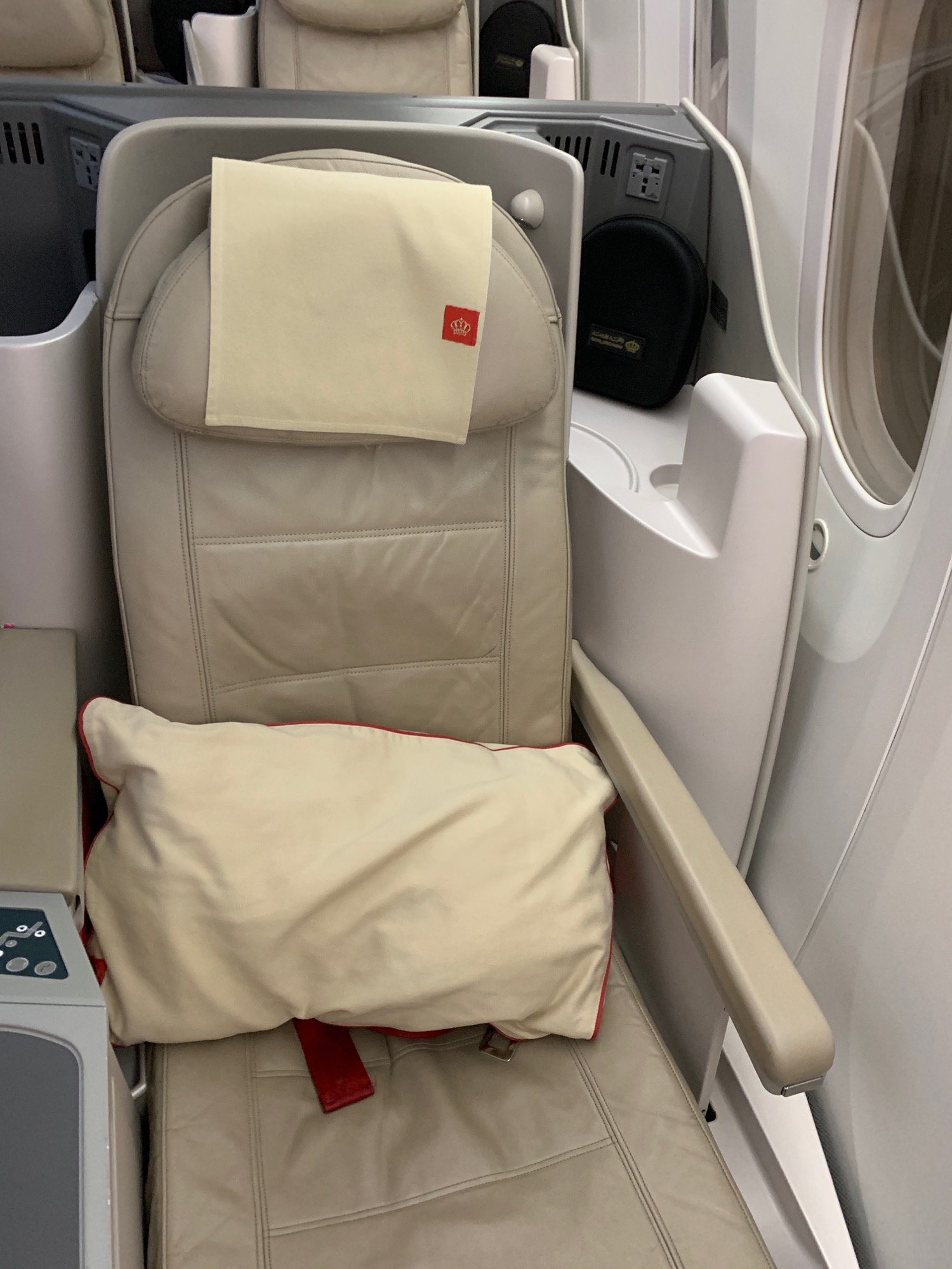 a seat with a pillow and a pillow on it