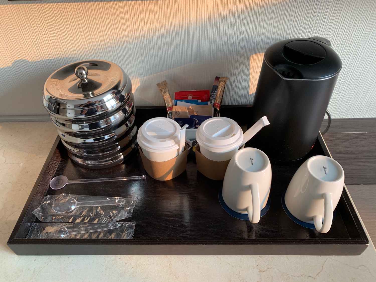 a tray with coffee cups and other items on it