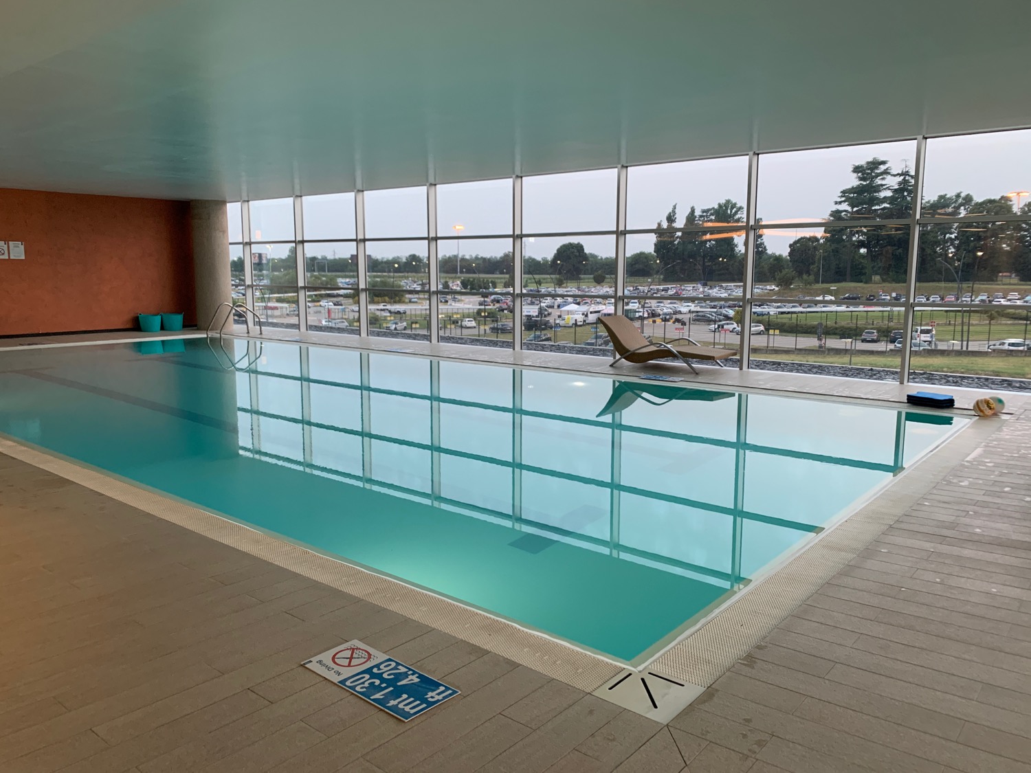 a indoor pool with a large window