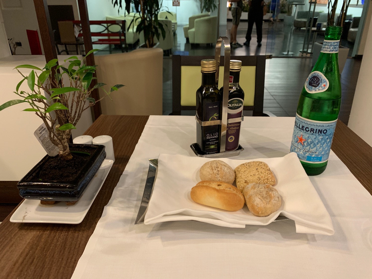 a plate of bread and bottles of beer on a table