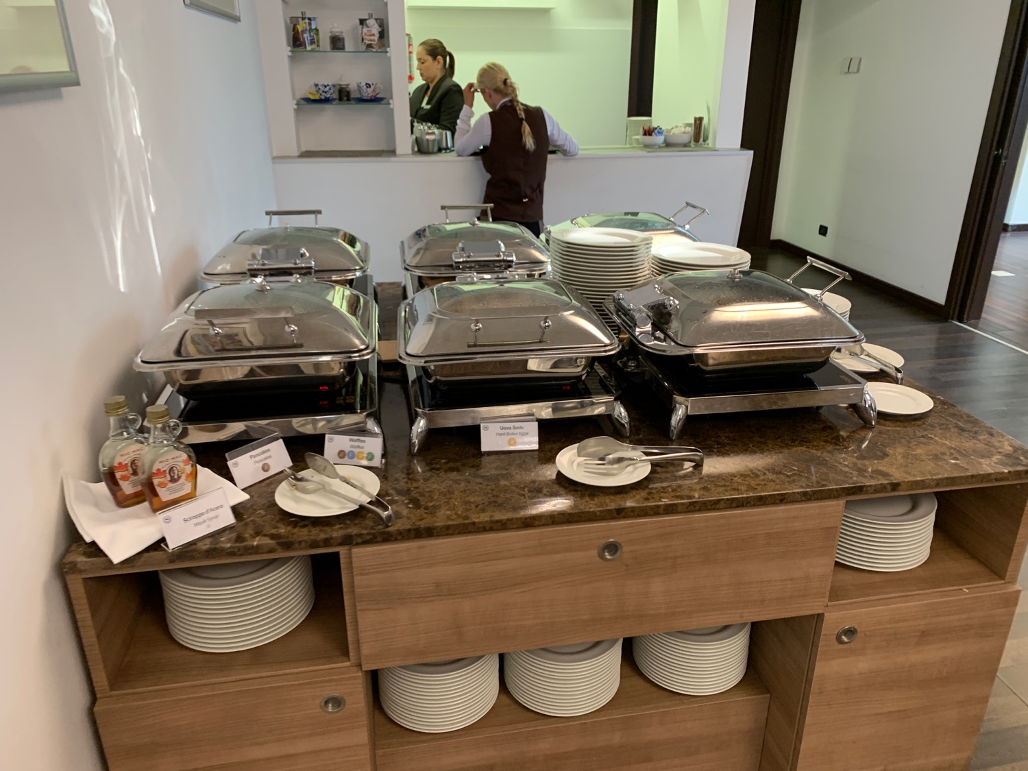 a buffet with many silver containers