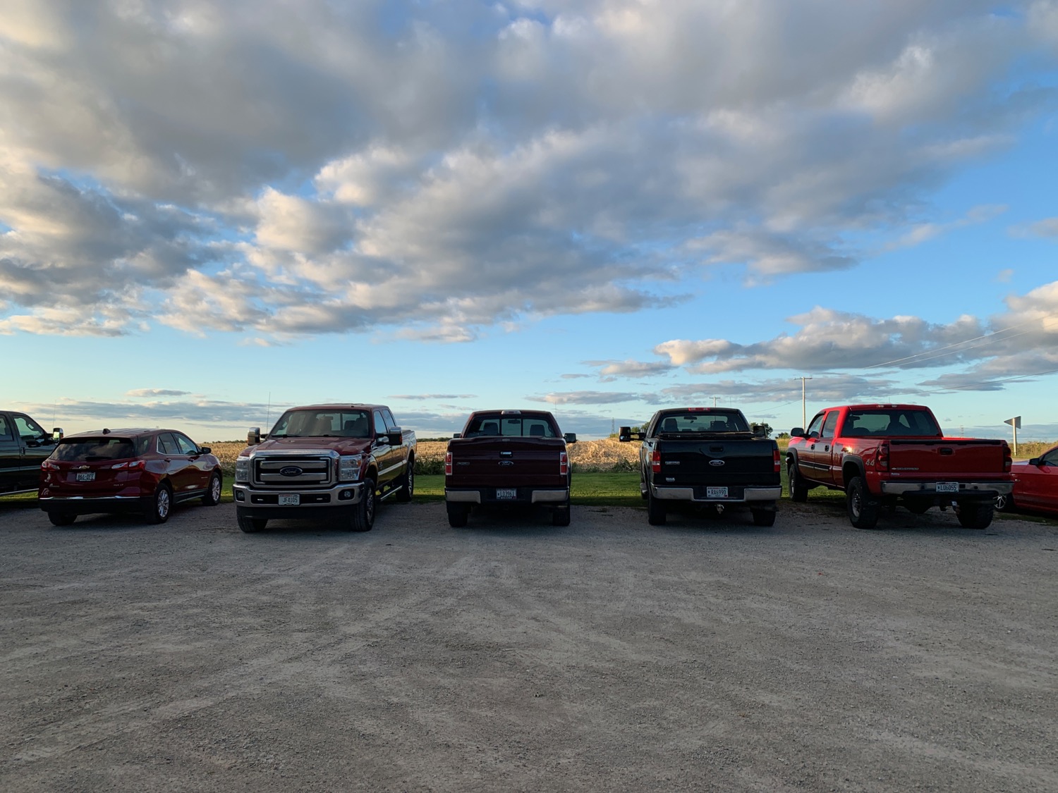 a row of pickup trucks parked in a parking lot