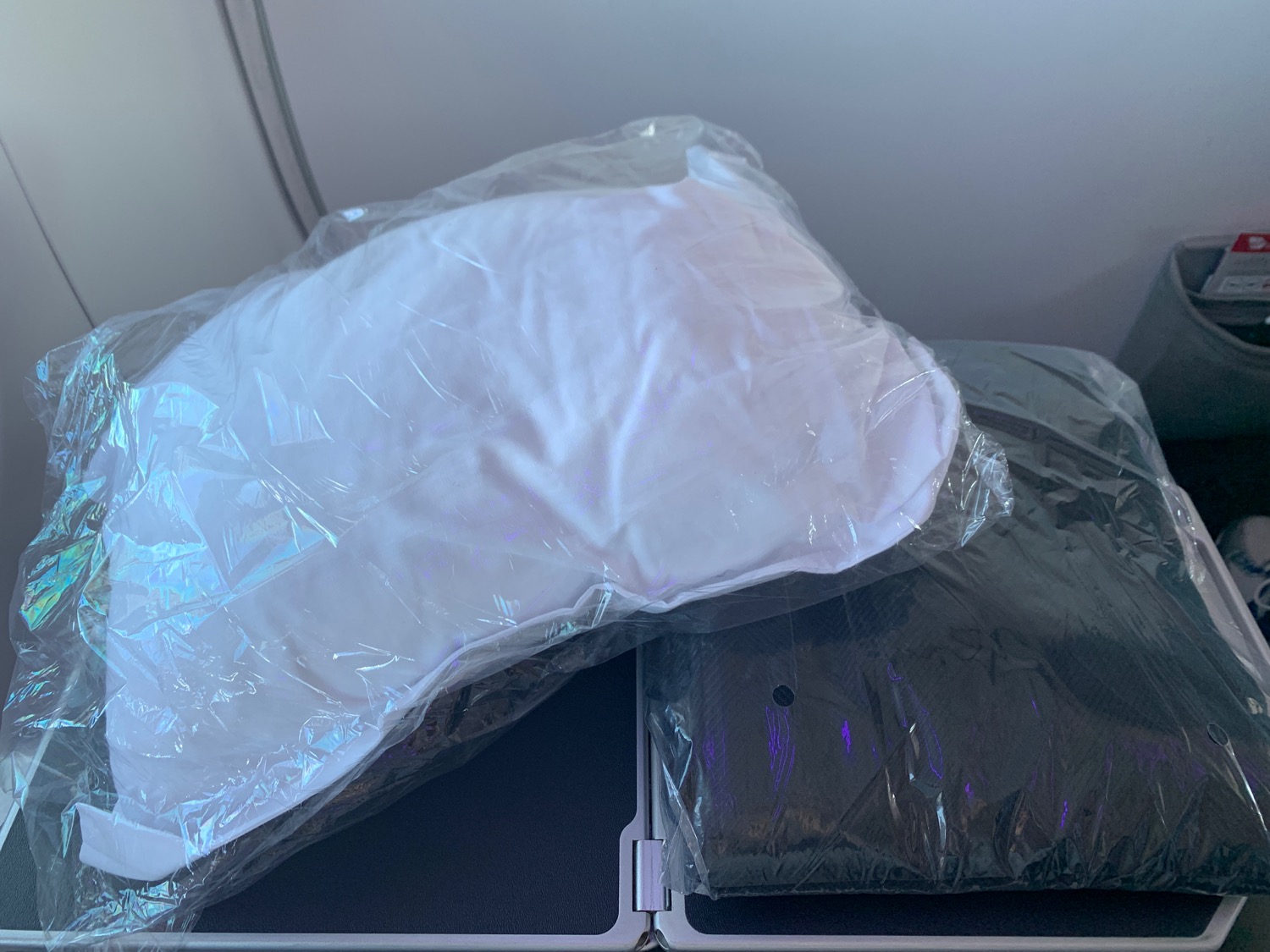 a plastic bag with a white pillow on top of it