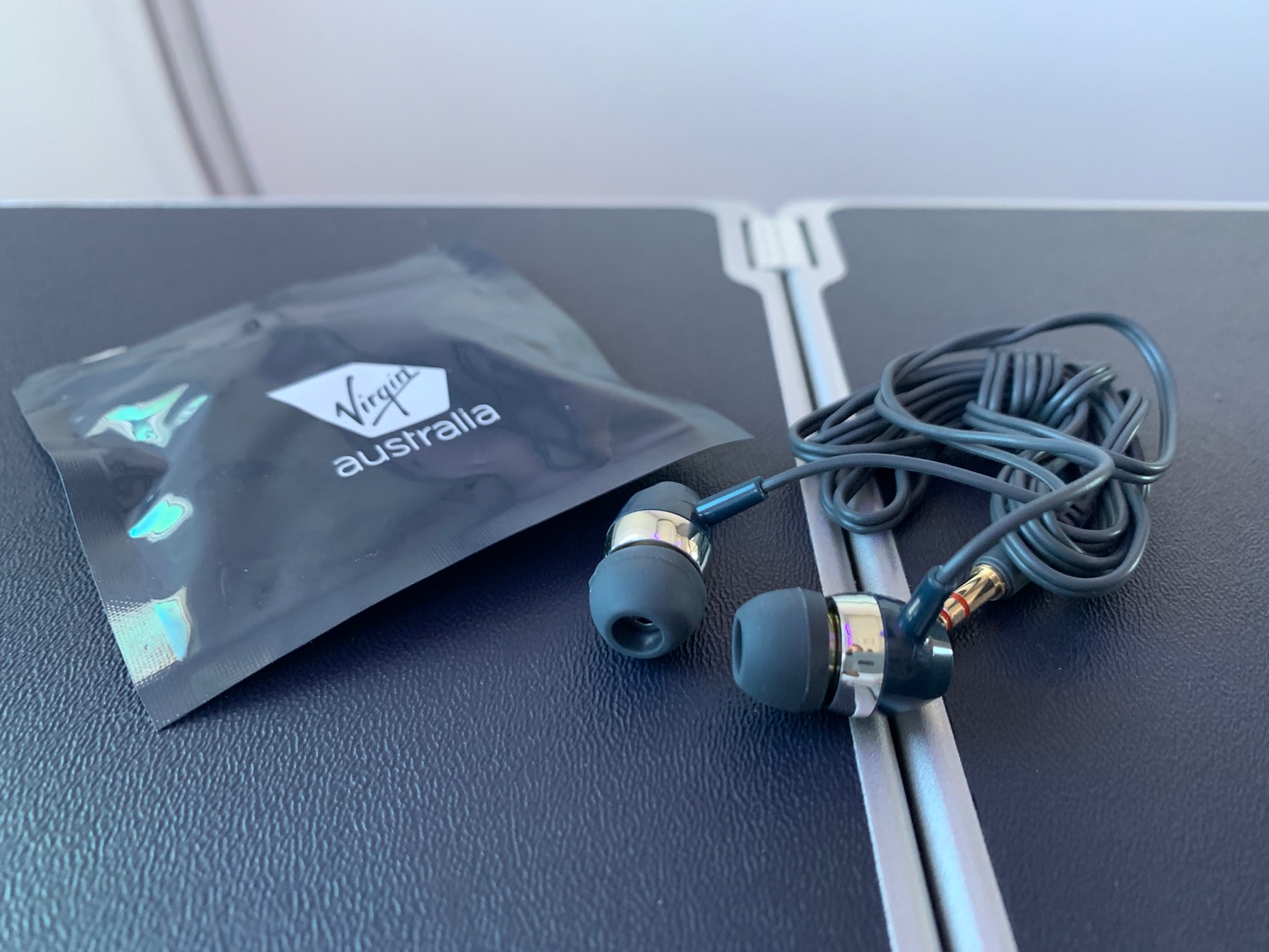 a pair of black earbuds on a black surface