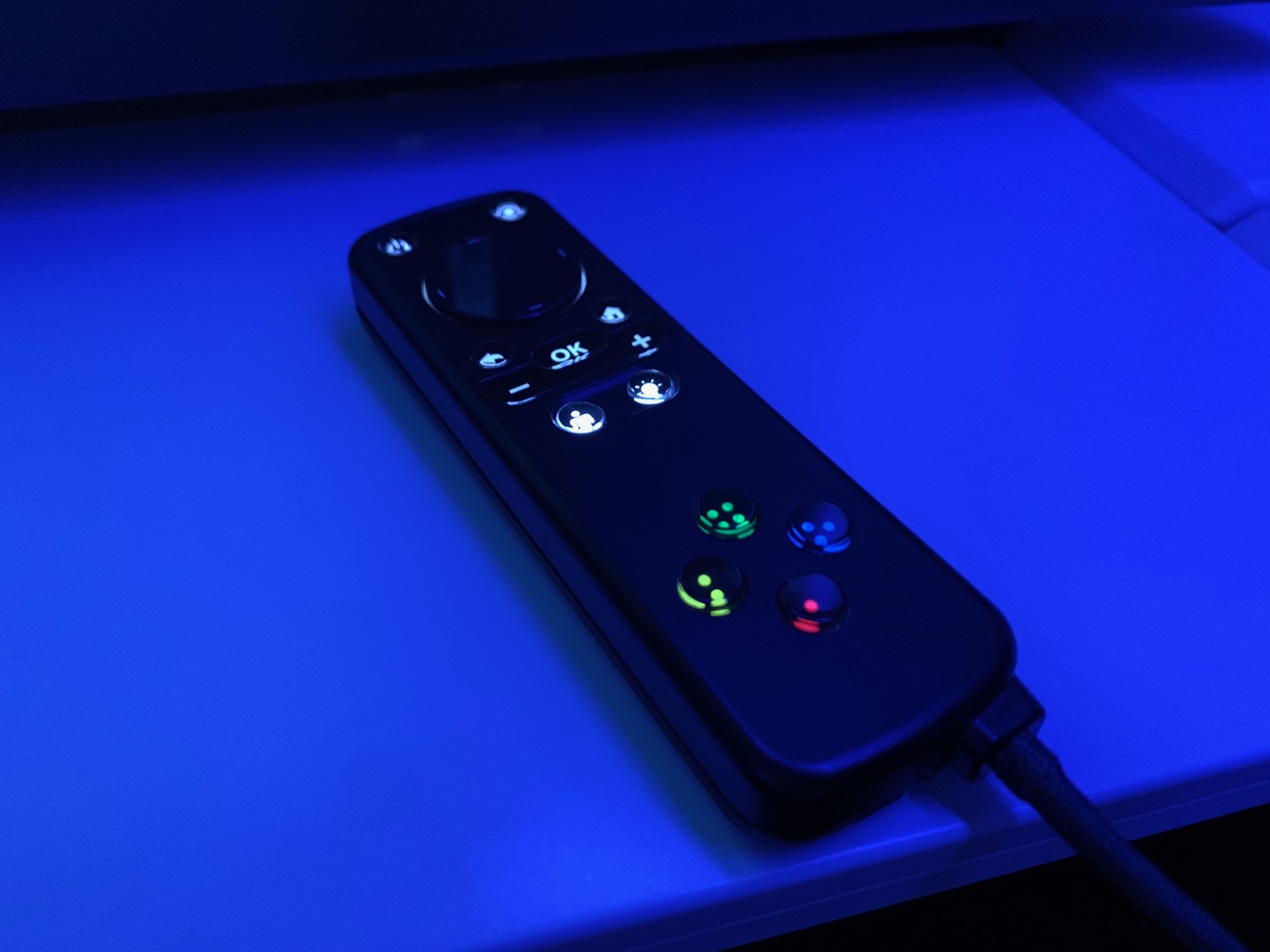 a remote control with buttons and lights