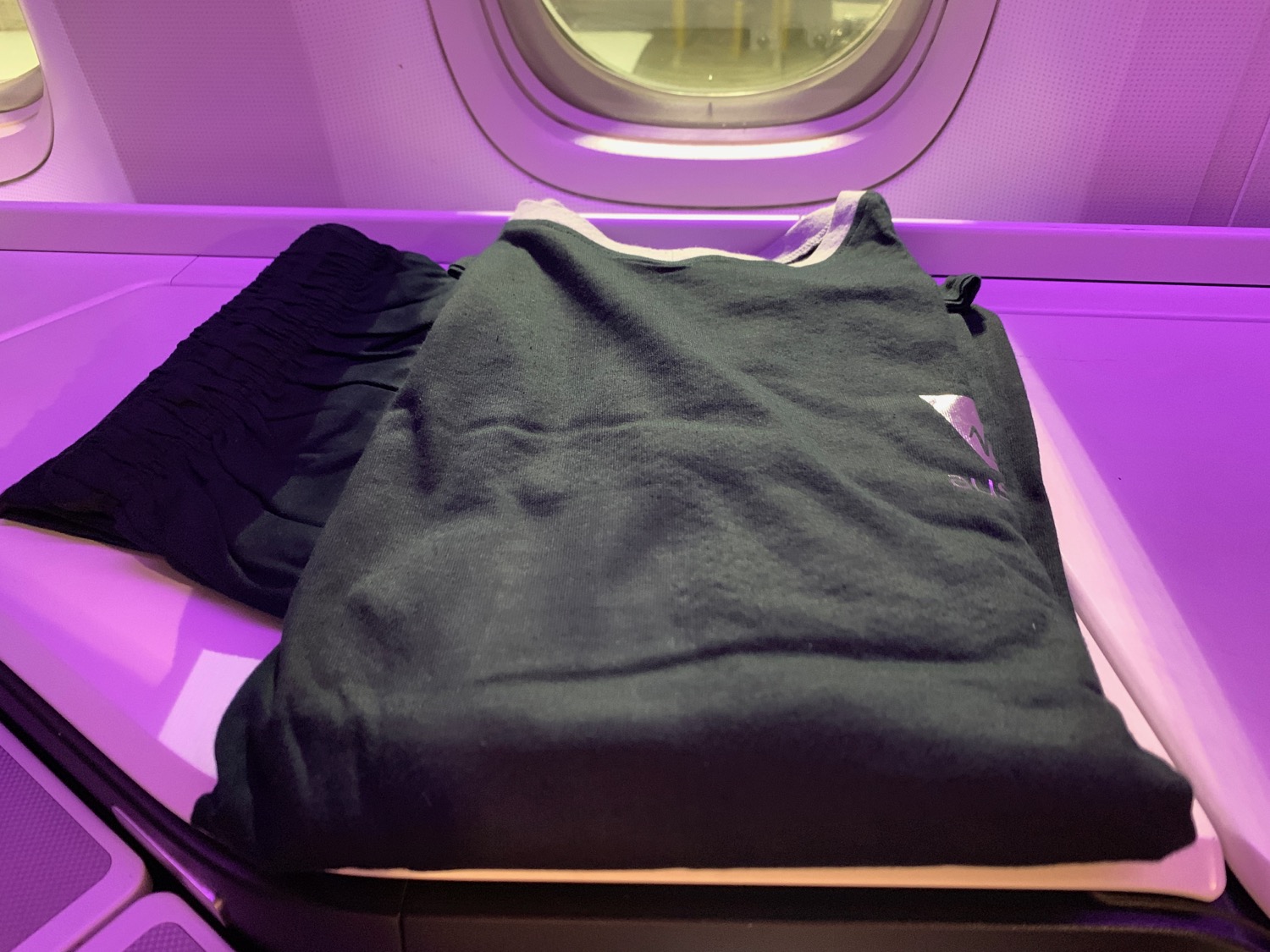 a black shirt and shorts on a plane
