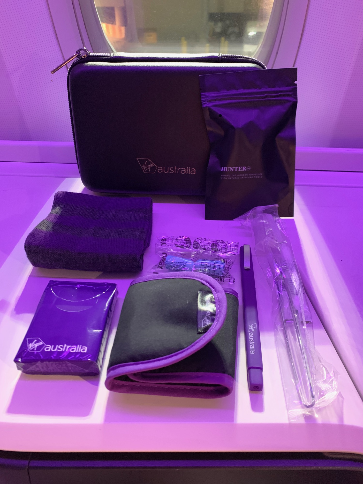 a purple bag with a pen and a pouch