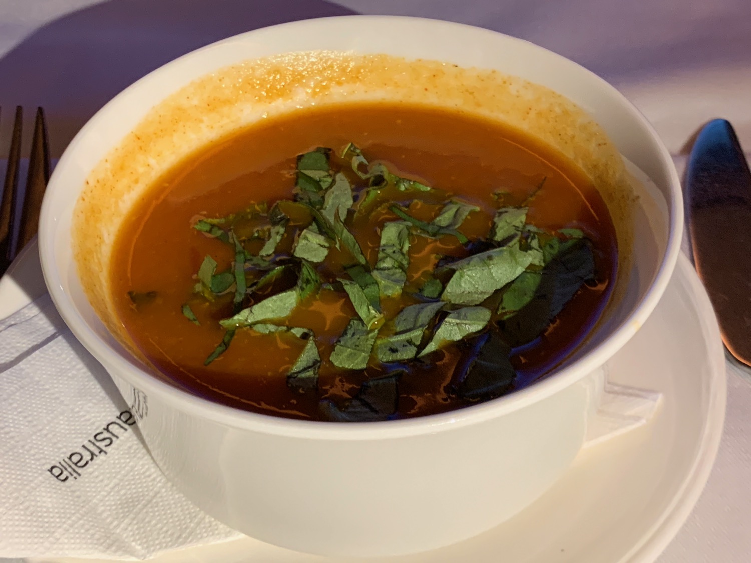 a bowl of soup with herbs in it
