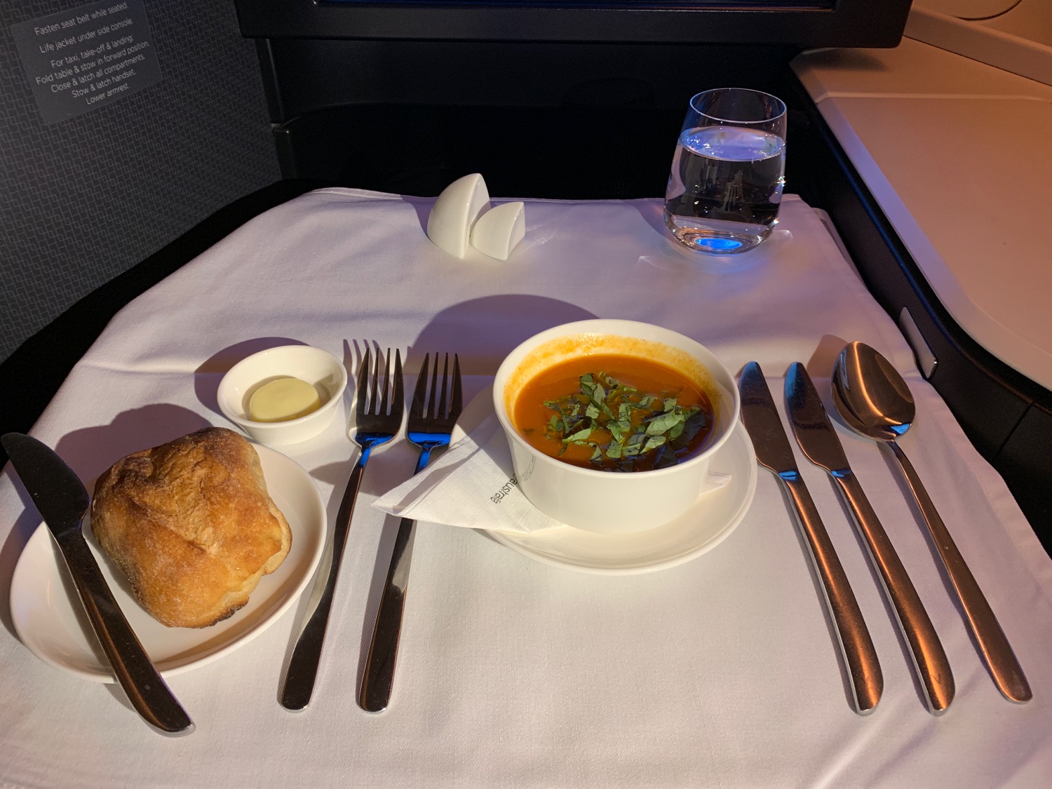 a bowl of soup and a bread on a table