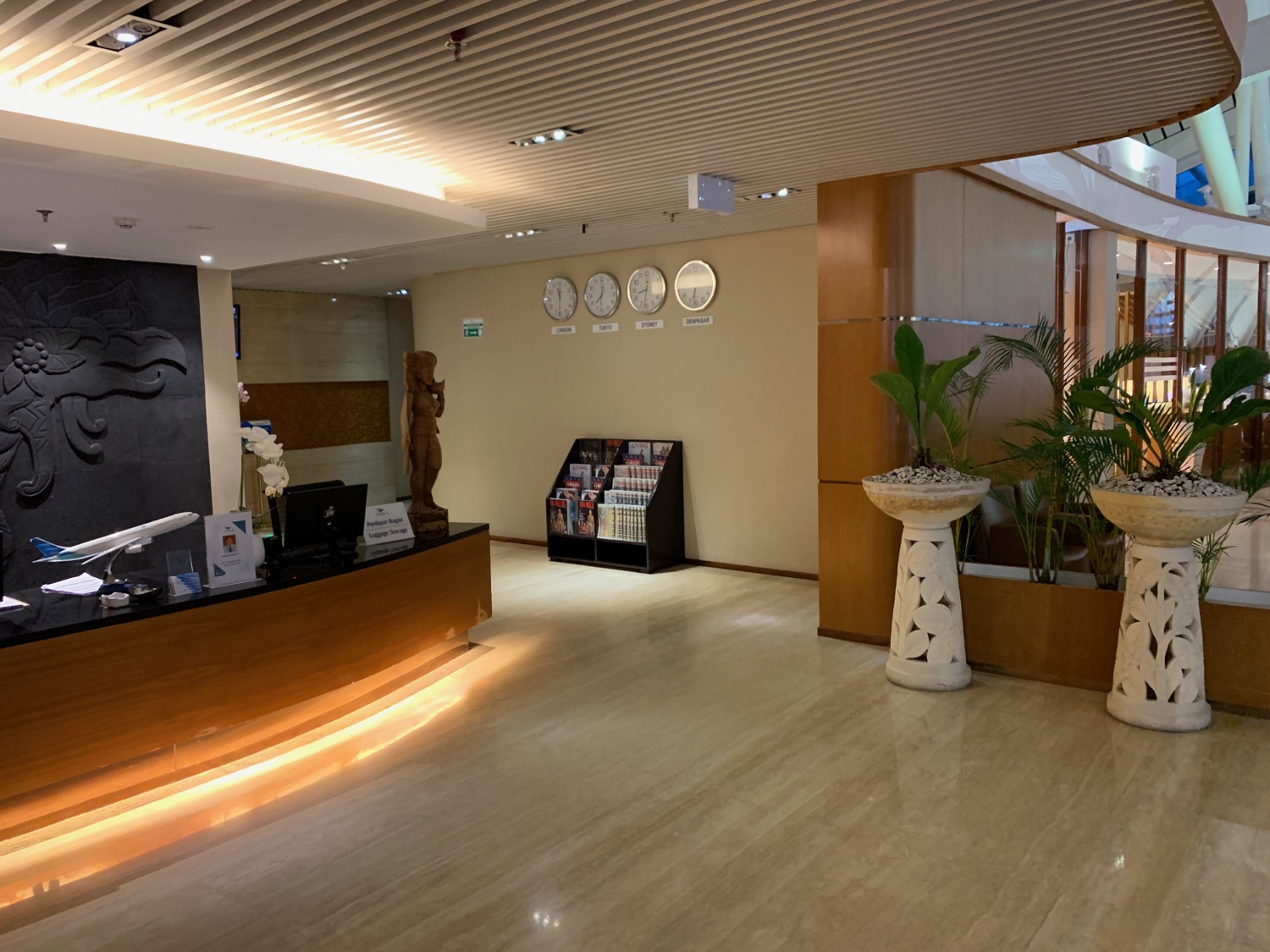 a lobby with a desk and a plant