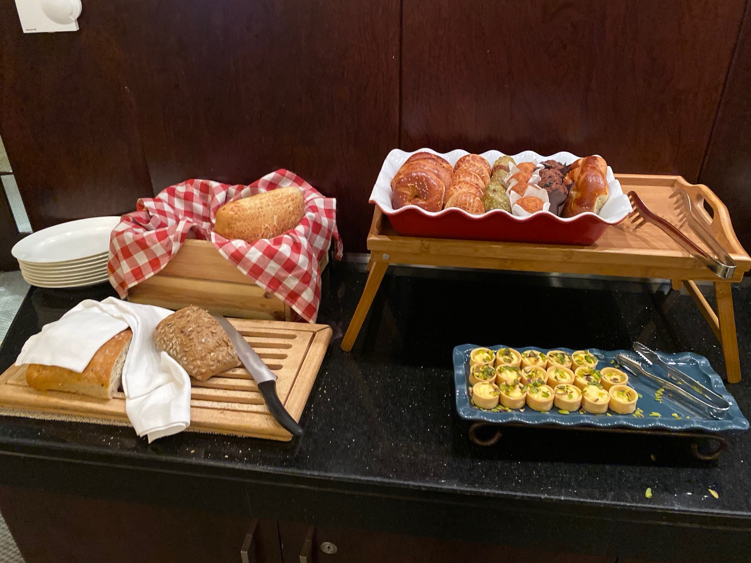 a tray of pastries and bread on a counter