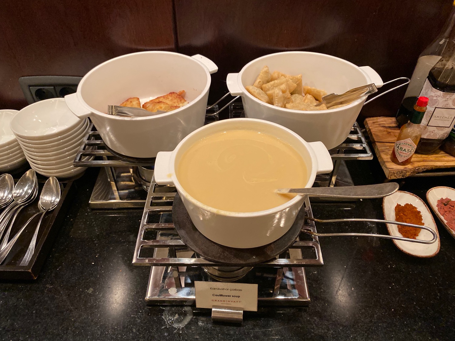 a group of white bowls with food in them on a table