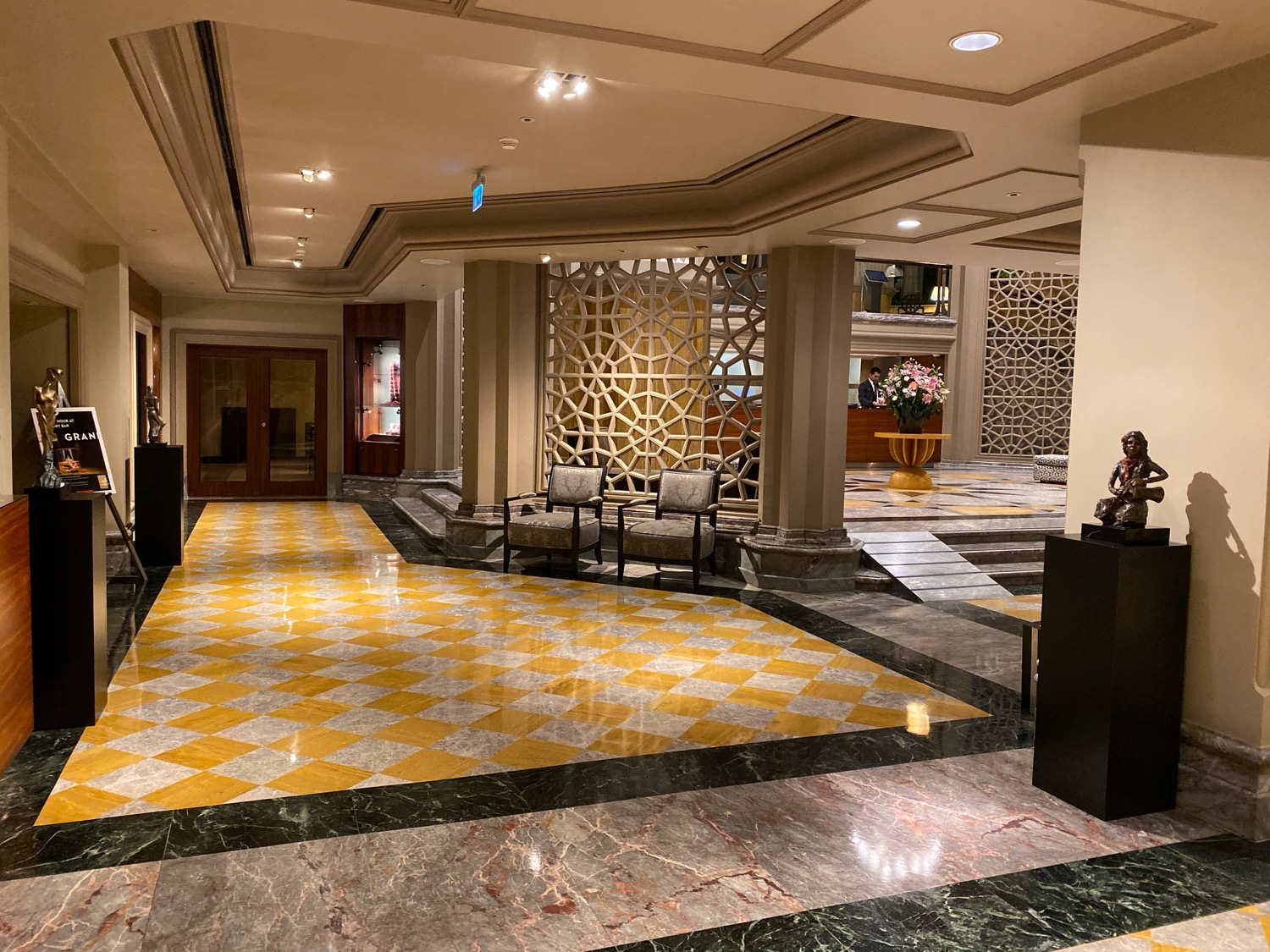 a lobby with a checkered floor and chairs