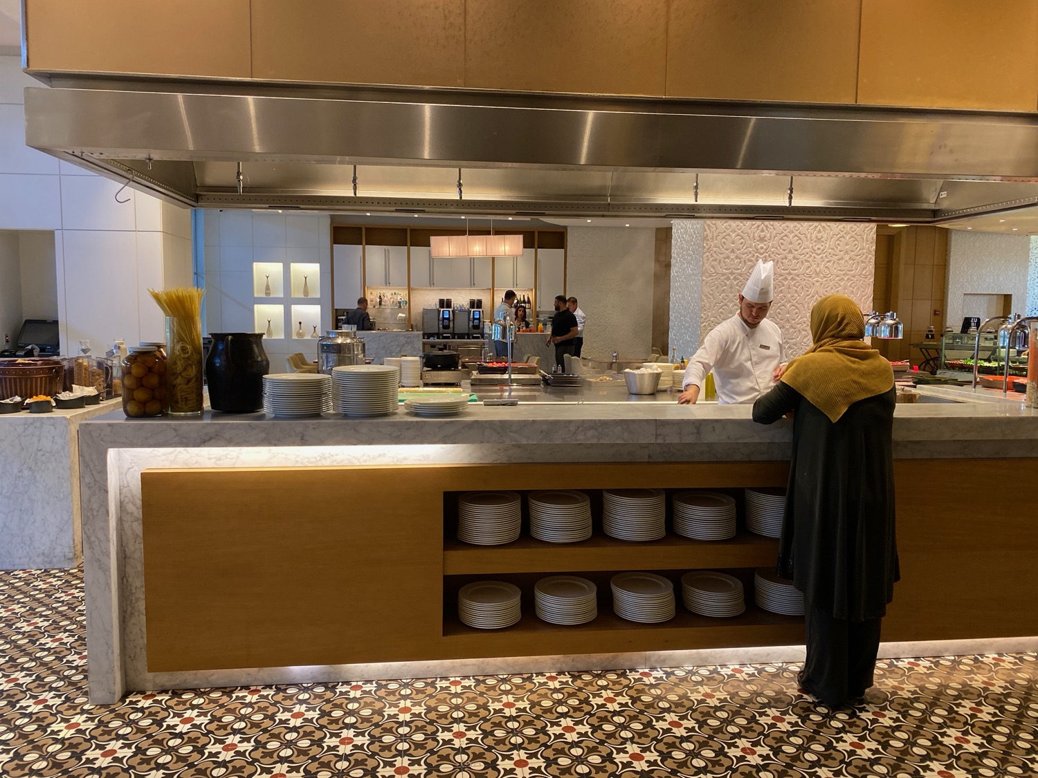 a chef standing at a counter in a restaurant